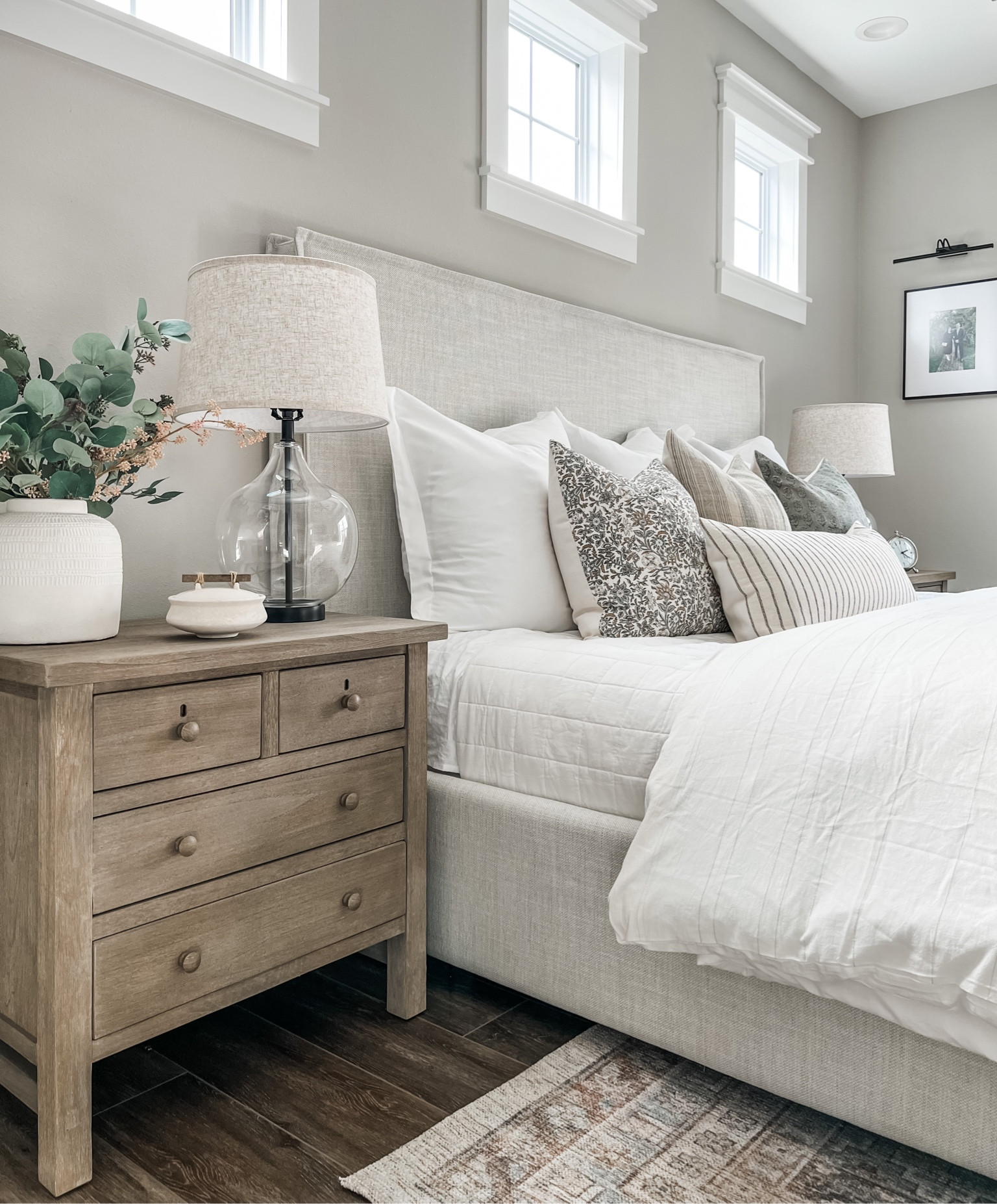 Primary bedroom / master bedroom / throw pillows / pillow covers / nightstand / glass lamp / vase / white vase / anthropology / highland park bed / upholstered bed / gallery light / rug / studio mcgee rug / quilt / duvet cover 

#LTKunder50 #LTKunder100 #LTKhome