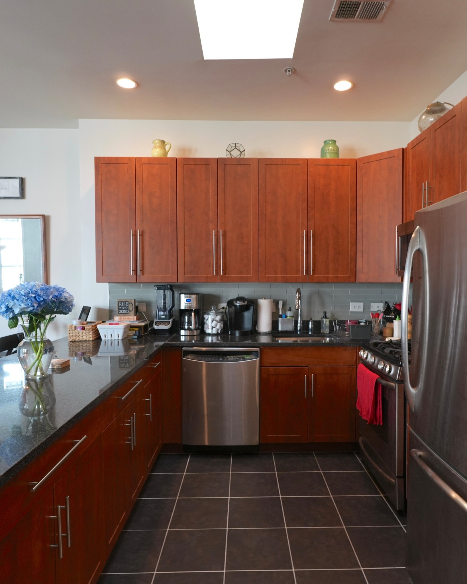 Our kitchen is one of my favorite spots in the apartment. The stainless steel fridge and dishwasher make cleanup easy, while the granite countertops give the space a polished look. I always keep my coffee maker out on the counter because it’s a must-have for mornings. The wooden cabinets add warmth and keep everything organized.

#LTKHome #LTKFindsUnder100
