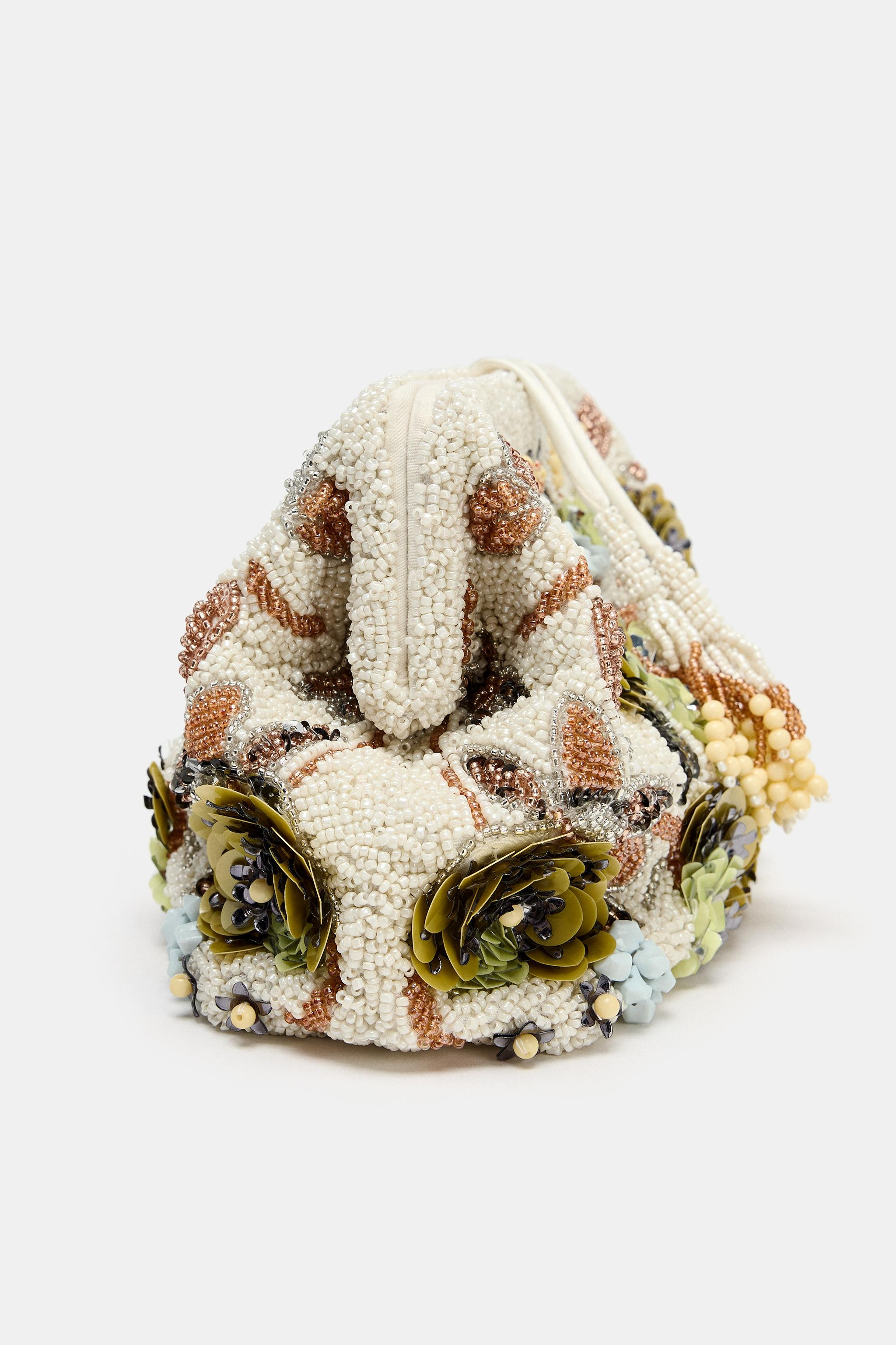 Pouch bag. Printed exterior with beads and appliqués. Interior pocket. Rigid hand-held design an... | Zara US