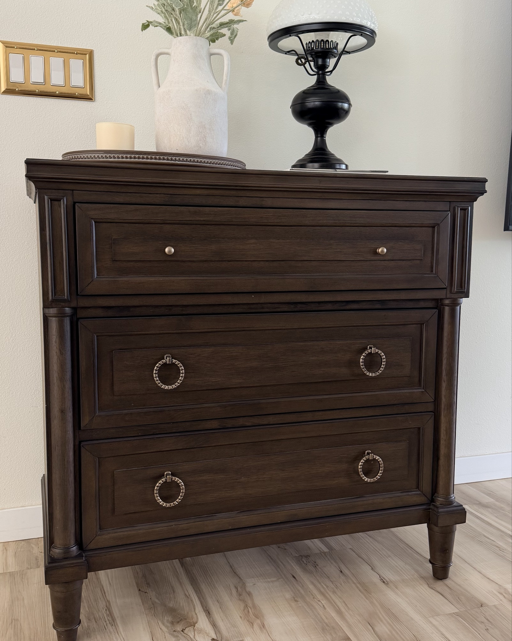A little dining room corner I love 🤍 I’m linking the Scott Living 3 drawer accent chest where I store my dining linens, along with the amber gold wall plate, oval wooden tray, and the Vanille Noisette candle from Quince. I also styled it with the off white ceramic handled vase and these champagne poppy stems, which add such a pretty soft touch to the space.

#LTKstorytime #LTKdayinmylife #LTKHome