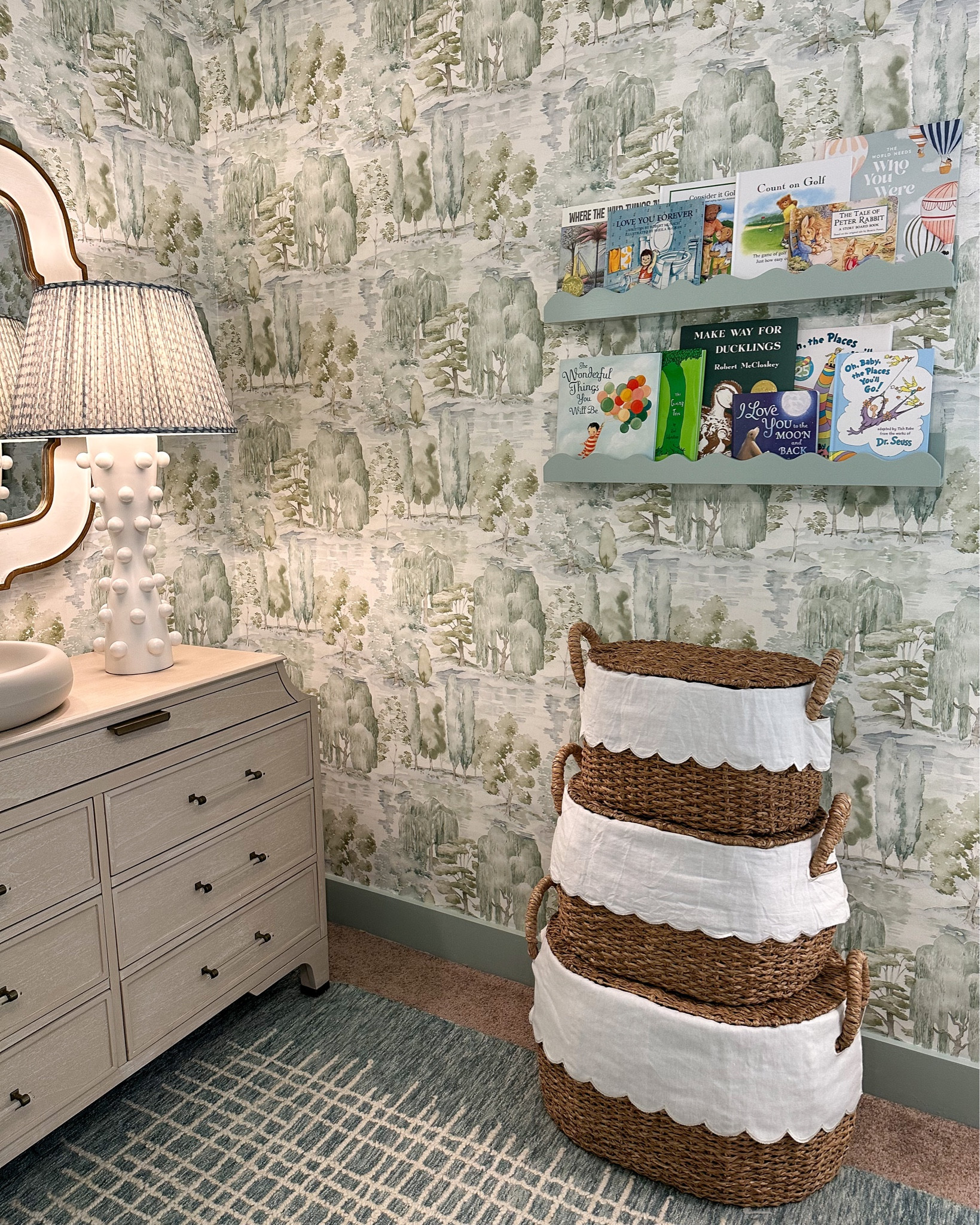 These little baskets and shelves are so sweet! I feel like the scalloped Ballard Bunny Williams baskets are a must in every nursery these days. Such a good stylish option for extra storage. And I had to match the scallop theme with these wavy shelves from West Elm that I painted to match the trim in Farrow Ball Green Blue. 

Linking everything I can! All the furniture, rug, and almost all lighting are from Mantooth Interiors in Homewood, AL. Give them a call to shop local and support my family’s business 🤍

#nursery #nurserydecor #nurserydesign #nurseryinspo #boynursery #genderneutralnursery #wallpaper #interiordesign #visualcomfort #myballardstyle #reginaandrewdetroit #reginaandrew #serenaandlily #potterybarn #westelm #gabbyhome #namesakecrib

#LTKbaby #LTKkids #LTKhome