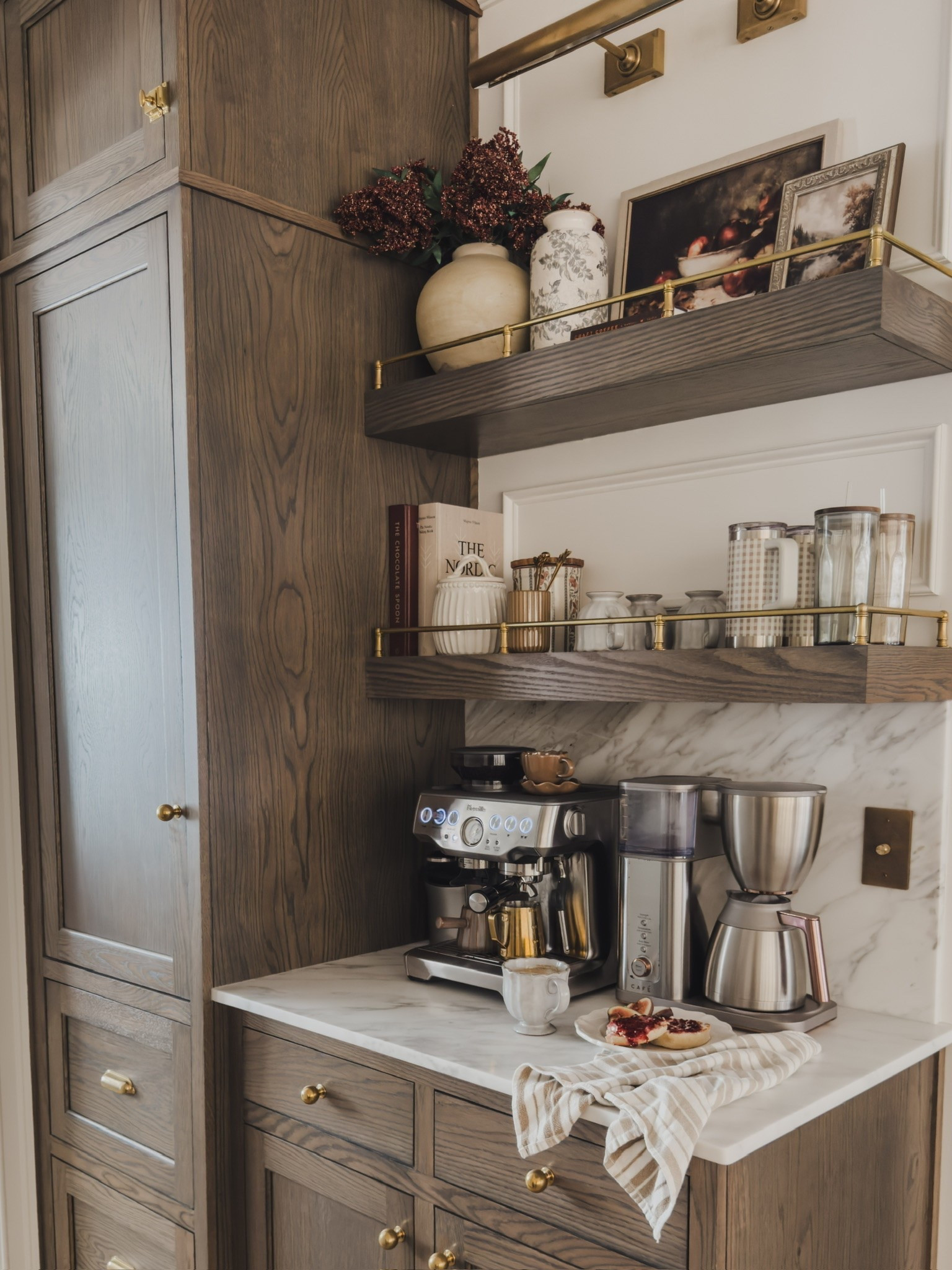 Fall coffee bar views! Keeping this area functional with just a touch of seasonal decor. Loving these viral berry stems paired with seasonal art and displaying all of my coffee bar essentials.

Home finds, neutral home inspo, fall coffee bar, collected style, rich wood tones, floating wood shelves, espresso machine, coffee essentials, neutral art, faux fall stems, neutral vase details, Nancy Meyer’s vibe, Wayfair, found it on Amazon, Pottery Barn style, Etsy, Target style, Breville, Cafe, shop the look!

#LTKSeasonal #LTKHome #LTKmorningroutine