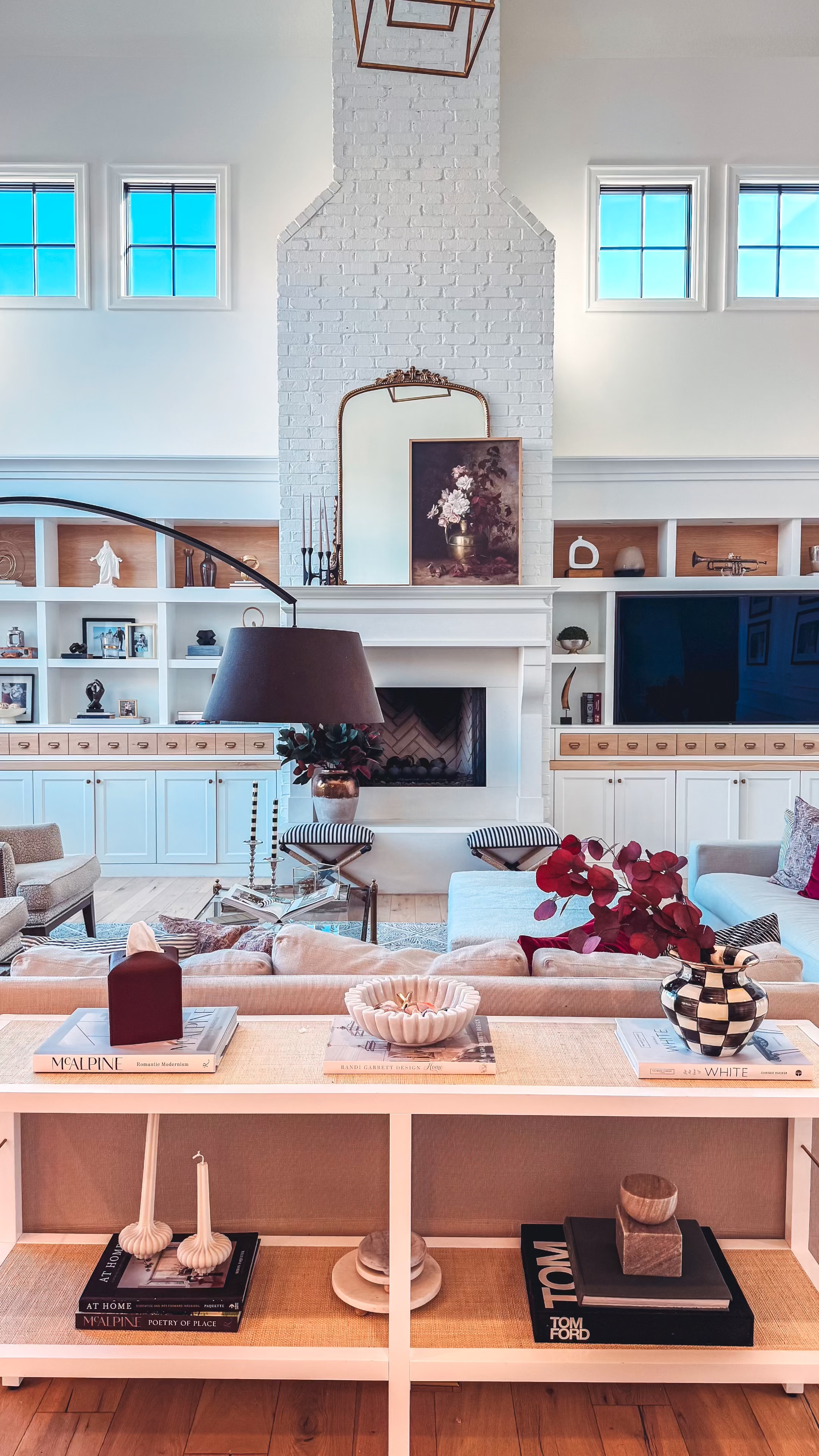 Romantic Valentines refresh for my living room.
Throw pillows, ceramic decorative dish, tissue box cover, courtly check Mackenzie Childs vase, coffee table books, still life floral oil painting, dried bergundy eucalyptus stems, magnifying glass, antique brass arched mirror, black multi taper candle holder, large slipcover bench seat sofa, rolling coffee table, large ottoman, leopard throw blanket, designer throw pillows & my favorite inserts! Valentine mantel decor. Black and white batik style wool area rug.

#LTKSeasonal #LTKHome