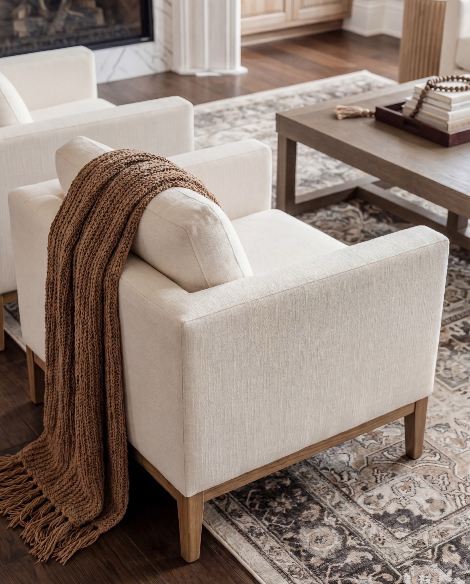 Shop the Look:
• Cream upholstered sofas
• Upholstered accent chairs (clean, modern arms)
• Marble-look fireplace décor
• Solid wood coffee table
• Neutral vintage-style area rug
• Large ceramic jug vase
• Wood + ribbed side tables
• Warm wood built-ins (or shelf styling accents)
• Throw blankets in warm caramel tones
• Neutral patterned pillows



#LTKHome #LTKFindsUnder100 #LTKSaleAlert