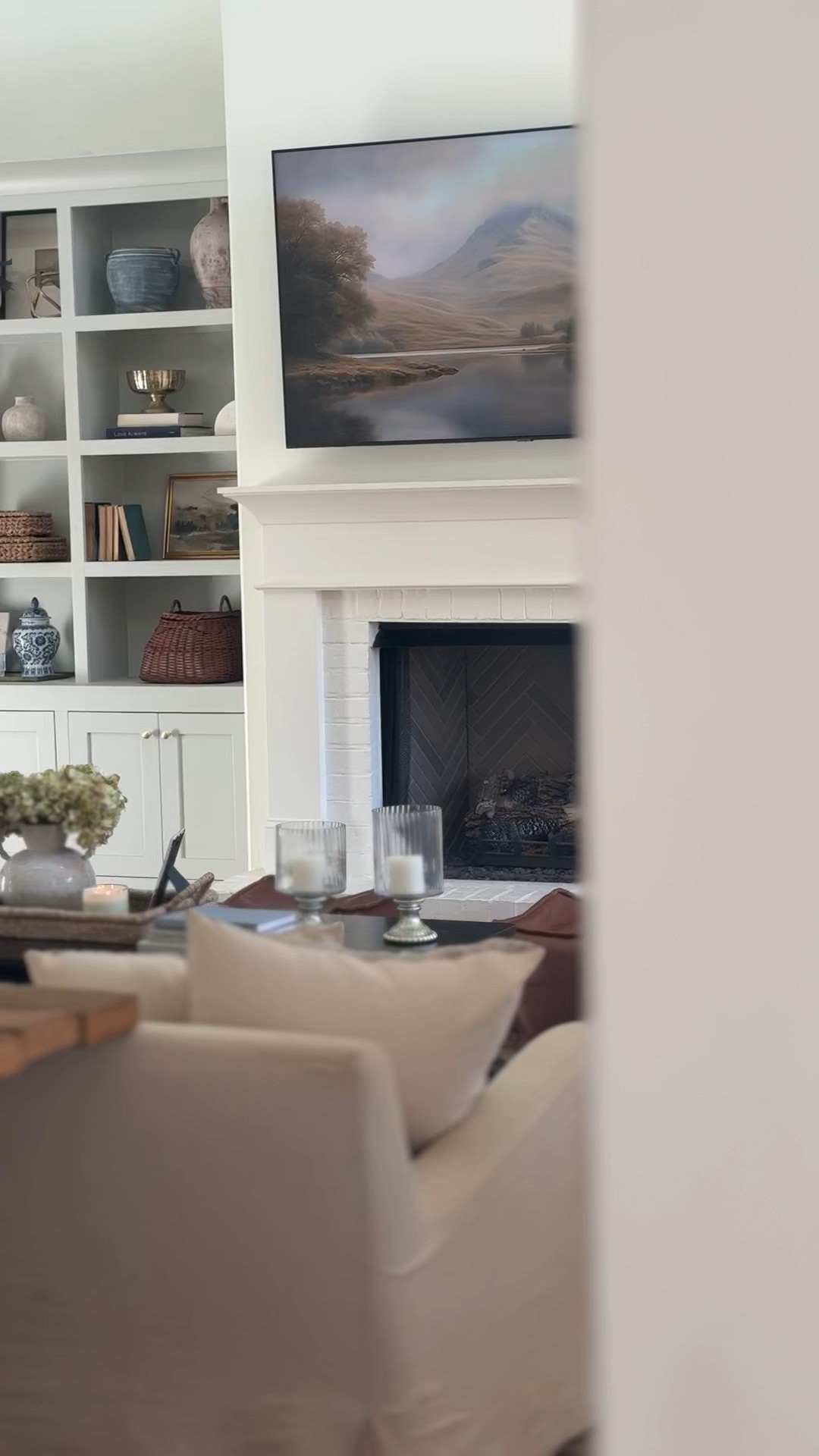 Living room views this winter 🤍 I refreshed our bookshelves and coffee table this week and leaned into more blues and soft neutrals for winter. I swapped the deep burgundy florals and book covers for lighter tones, and changed out a few pillow covers to brighten things up. Just a handful of simple swaps, but it made the whole room feel fresh again. 

#LTKHome