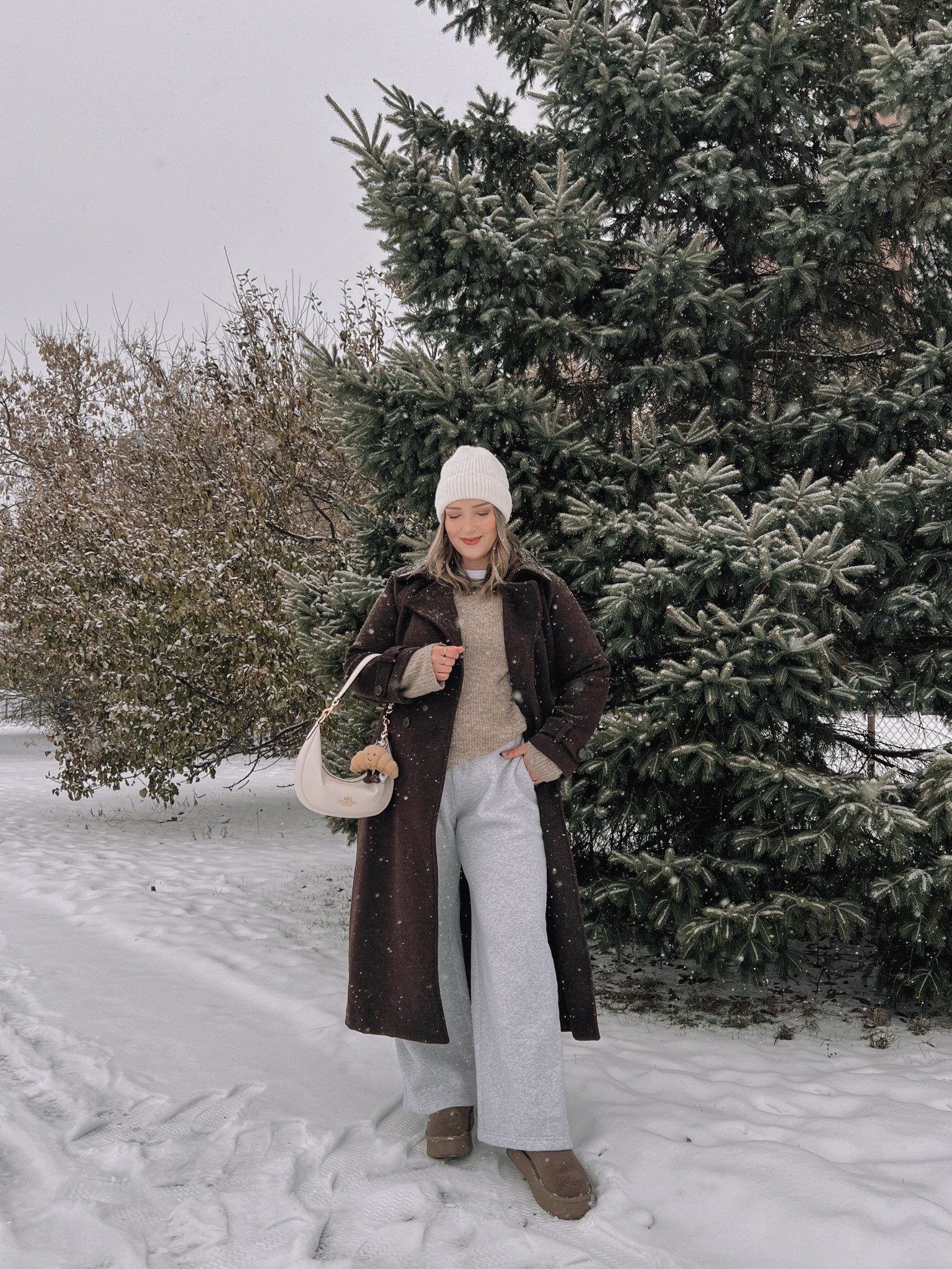 Cozy winter outfit! Wearing my usual size L in the chocolate brown wool trench coat - it’s so warm and such a good staple piece! Also wearing L in the wide leg sweatpants, these are thick and cozy and cute enough to wear out! This white tee is my fave for layering since the neck is higher, wearing my usual size L. My Ugg style boots are Amazon and such good quality! I’m usually a 9.5-10 and wear a 10 in these. Linked similar neutral sweaters & cream beanie

#LTKmidsize #LTKwinter #LTKstyletip