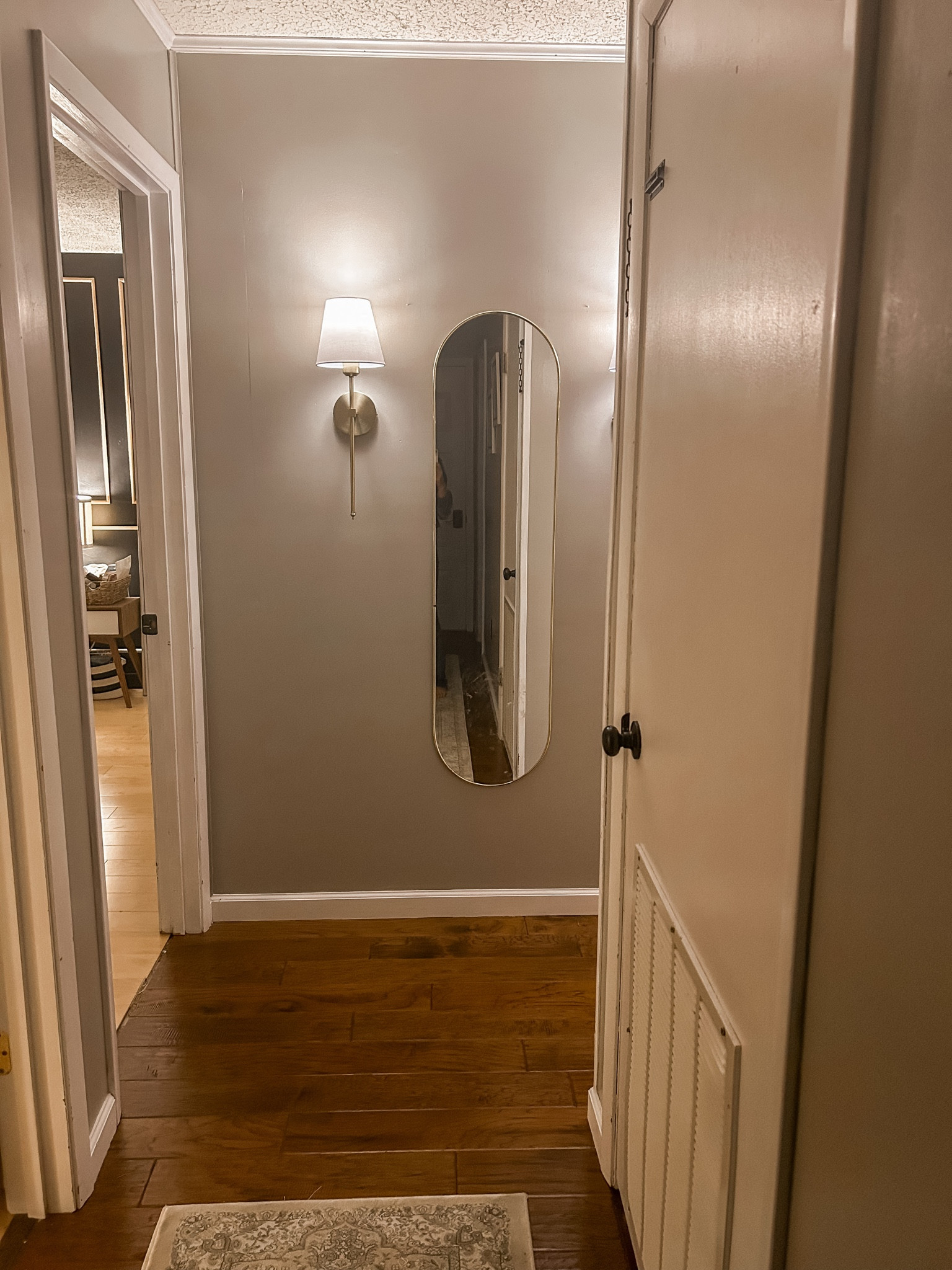 Hallway decor, gold wall design. Long gold oval mirror and battery powered wall sconce with no wiring needed! 

#LTKhome #LTKFind #LTKstyletip