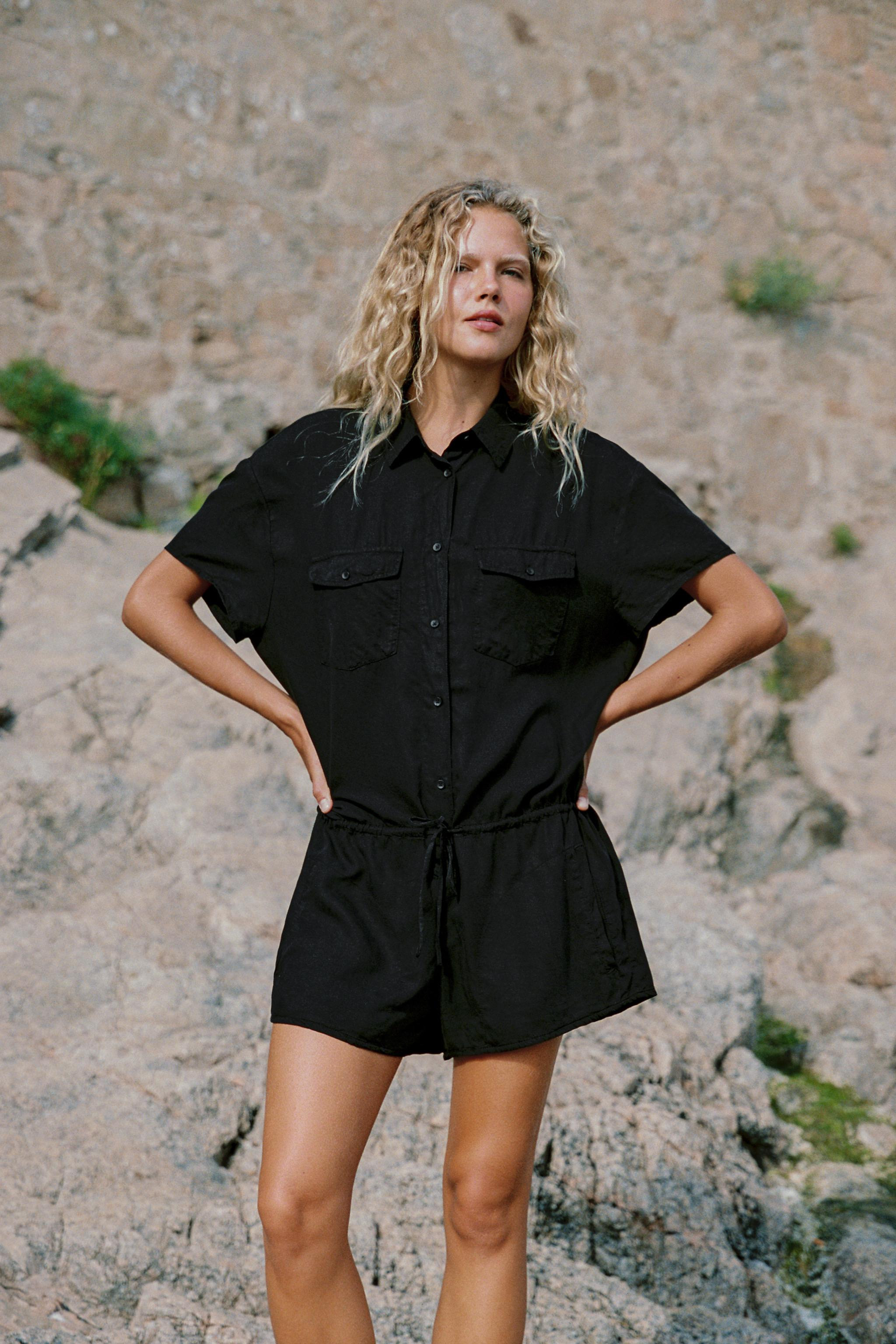 Short jumpsuit made from a 65% lyocell blend. Lapel collar and short sleeves. Adjustable waist wi... | Zara US