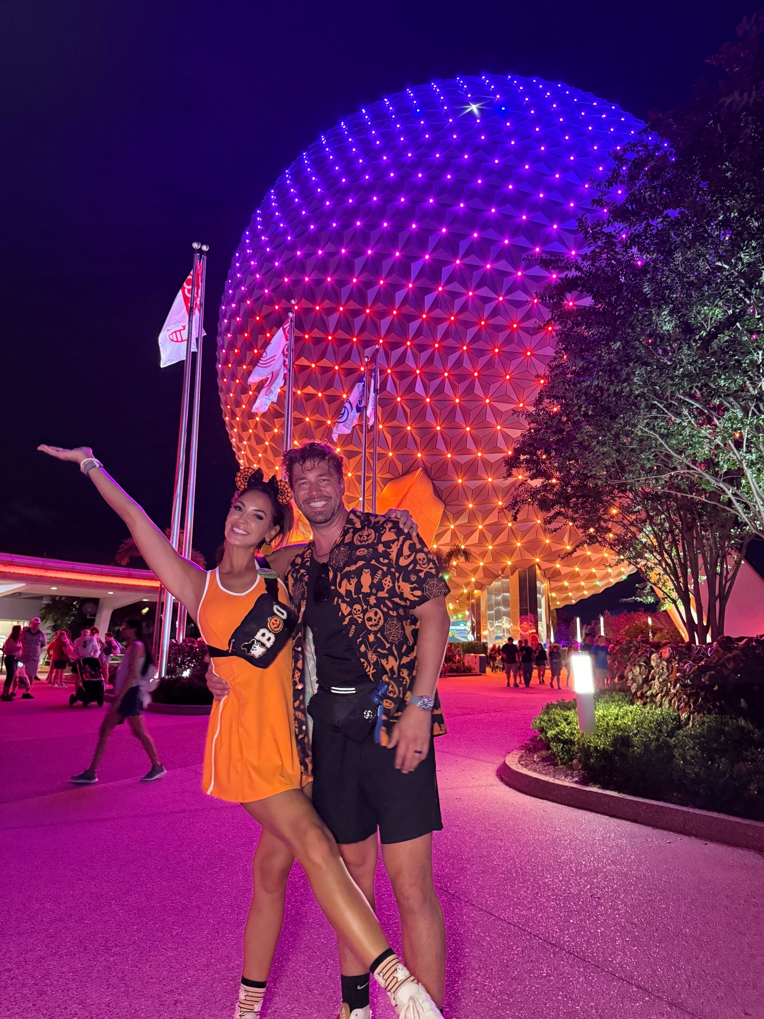 Mickey’s not so scary Halloween party! Halloween outfits for Disney or any day! Loved this orange dress, Halloween bag, and Halloween men’s shirt! #halloweenoutfit #halloween #disneyworldoutfit #disneyworldootd 