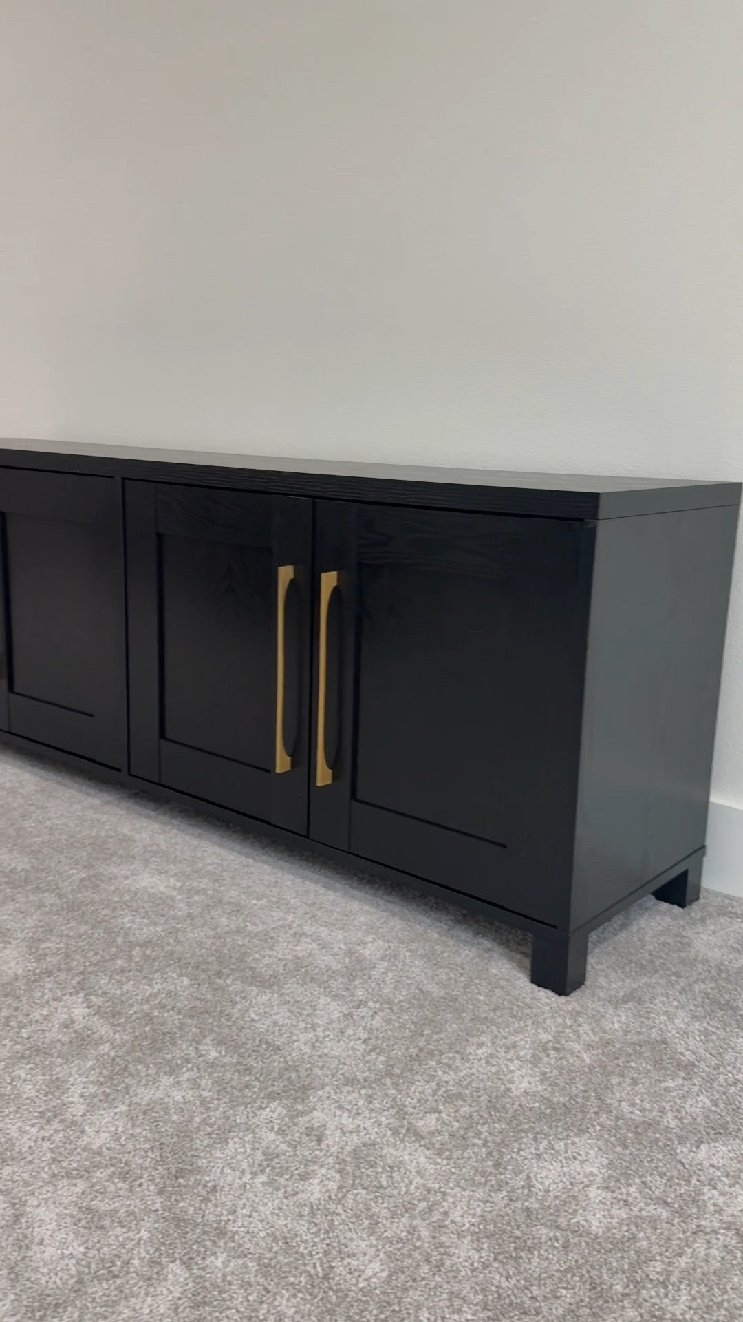 This TV stand has been such a hit in our bonus room and I keep getting asked about it 🤍 The black wood grain texture and gold hardware give it such a high-end look — nobody would guess how affordable it is. Linking it plus a few other media stand and TV stand options that have the same elevated feel without the designer price tag.

#LTKSaleAlert #LTKHome
