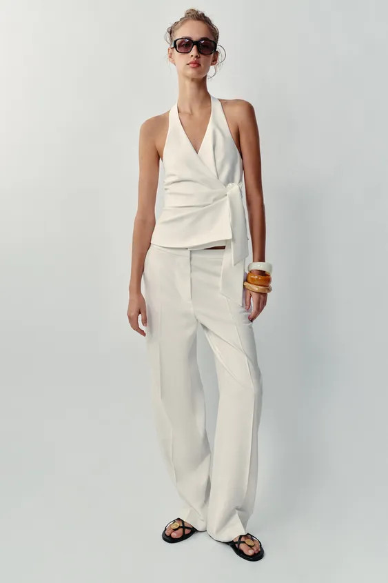 Model height: 173 cmMid-waist trousers featuring front pockets and false back welt pockets with b... | Zara UK