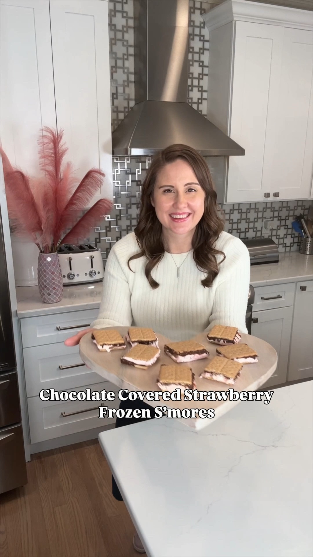 Frozen s’mores… but make them chocolate-covered strawberry vibes 🍓✨
This no-bake dessert is creamy, chocolatey, and straight-from-the-freezer GOOD.

Layers of graham crackers, fluffy marshmallow, whipped topping, cream cheese, and rich chocolate with a hint of strawberry = an easy treat that feels extra special without turning on the oven.

Perfect for Valentine’s Day, date night, or anytime you want something sweet and fun 💕

I linked everything to make this one super easy to recreate.

Save this for later and thank me later 😌

Recipe 👇

You’ll need:
• 1 box graham crackers
• 3 oz dark chocolate pudding mix
• 1 cup mini chocolate chips
• 8 oz marshmallow fluff
• 8 oz frozen whipped topping (thawed)
• 4 oz cream cheese (softened)
• Strawberry extract (to taste)

How to make it:
1️⃣ Mix pudding, cream cheese, marshmallow fluff, whipped topping, and strawberry extract until smooth
2️⃣ Fold in mini chocolate chips
3️⃣ Layer graham crackers + filling, repeating until full
4️⃣ Freeze until set, then slice and enjoy ❄️

#NoBakeDessert #FrozenDesserts #SmoresDessert #ValentinesDesserts #ChocolateCoveredStrawberries #EasyDesserts #SweetTreats #DessertInspo #LTKFamily #LTKVideo

#LTKValentine #LTKSeasonal #LTKfoodie