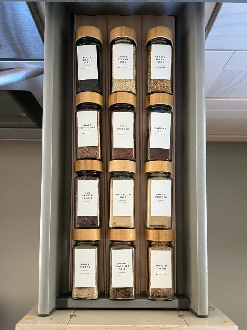 This family has 4 pull-out spice drawers that don't fit traditional spice jars standing upright. Not even a smaller 2 ounce jar! In this case, the only system that worked was laying the jars flat for them. We also ordered custom labels for the jars since they have unique spices. This Etsy vendor was amazing to work with! 

 #LTKHome