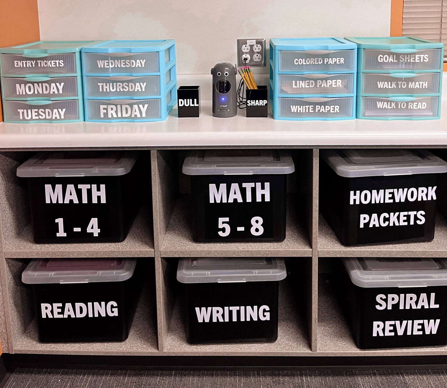 I’m loving this organized space in my classroom! I am using the r blue drawers to store things that I will use daily throughout the week. The black bins store extra copies and things like unit assessments. And if you don’t already have this pencil sharpener then you are missing you! 