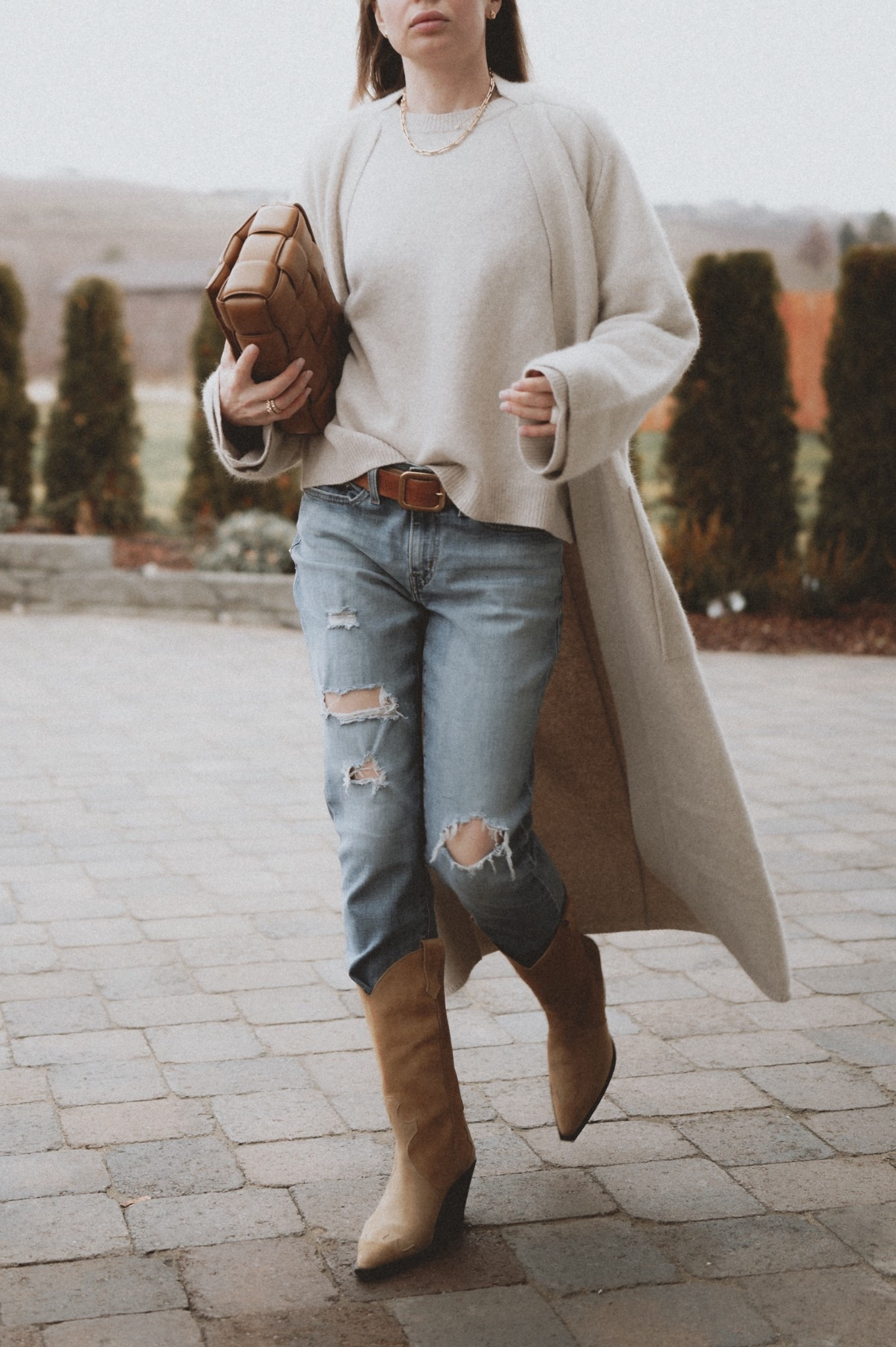 Opinion needed: are the ripped jeans actually coming back? 👖 
My very old Levi’s @Levi's styled with a @louloudesaison Tristan sweater & Smet cardigan. Boots: Aeyde, linked similar. Bag: Bottega Veneta. Necklaces: Kinn. 

#LTKootd #LTKSeasonal #LTKSaleAlert