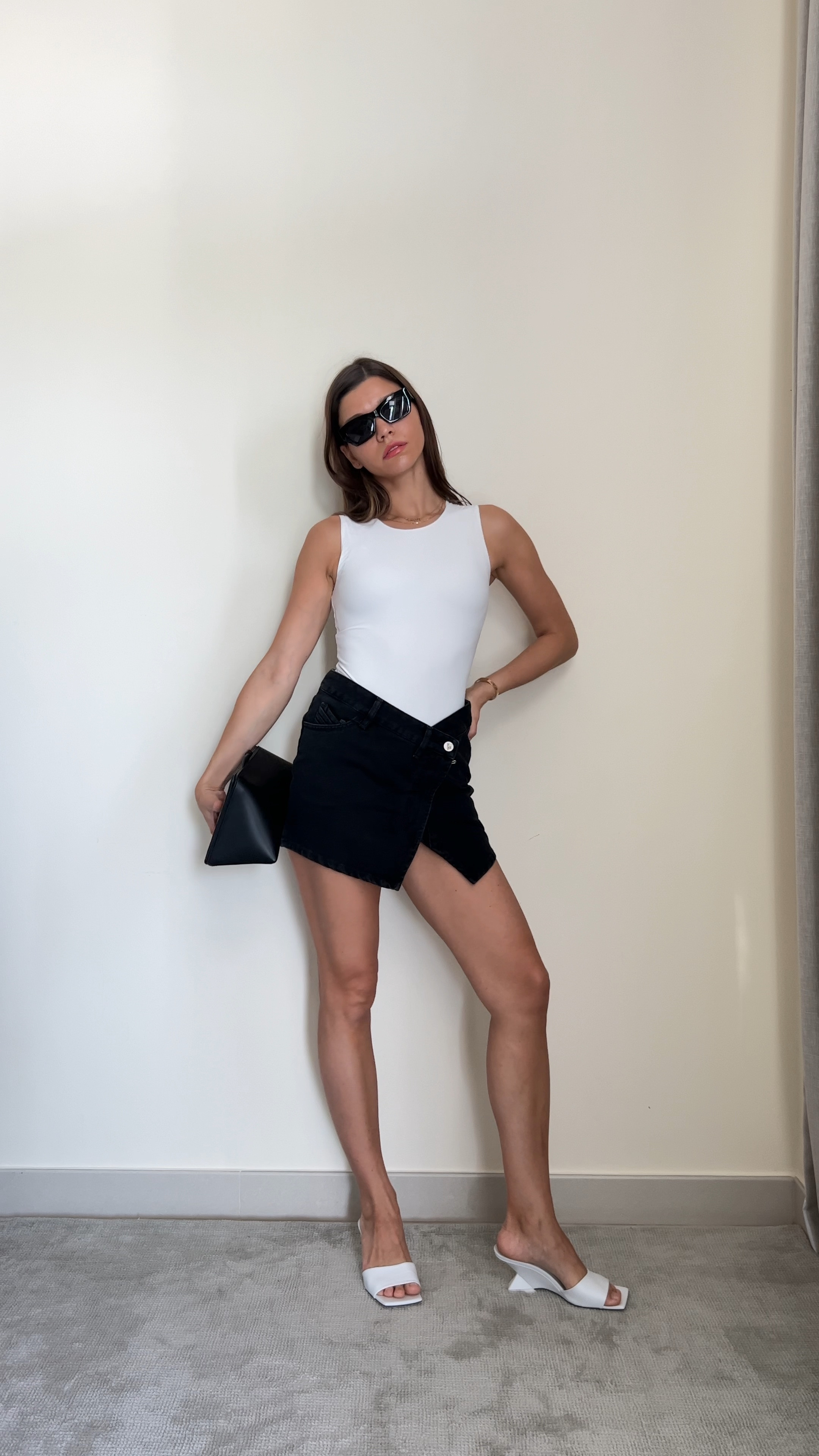 Summer Night Outfit idea : white bodysuit, black wrap skirt, black clutch bag, white mules with asymmetrical heel 

#LTKshoecrush #LTKFind