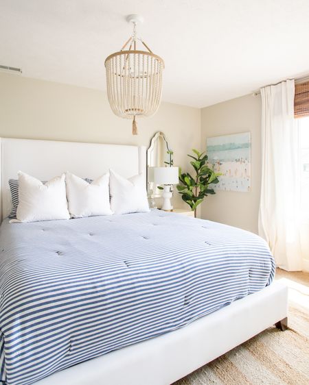Our previous guest bedroom decor includes a beachy abstract art, faux fiddle leaf fig, an upholstered bed, a blue and white striped comforter, white pillows, striped throw pillows, a ceramic table lamp and a wood beaded chandelier, a beveled frameless mirror, linen blackout curtains  

simple decor, bedroom decor, fiddle leaf fig tree, bedroom lighting, bedroom mirror, guest bedroom inspiration, area rug, target chair, amazon home decor, master bedroom decor, pottery barn bed, pottery barn inspired room, coastal bedroom, bedroom bedding, abstract art, canvas wall art, classic design, simple decorating, target style, abstract wall art, bedroom rugs, guest bedroom décor, target home décor, amazon finds, serena and lily bedding, master bedroom, guest bedroom, bedroom decorating #ltkfamily #ltkfind 

#LTKSeasonal #LTKstyletip #LTKunder50 #LTKunder100 #LTKhome #LTKsalealert #LTKsalealert #LTKhome #LTKSeasonal