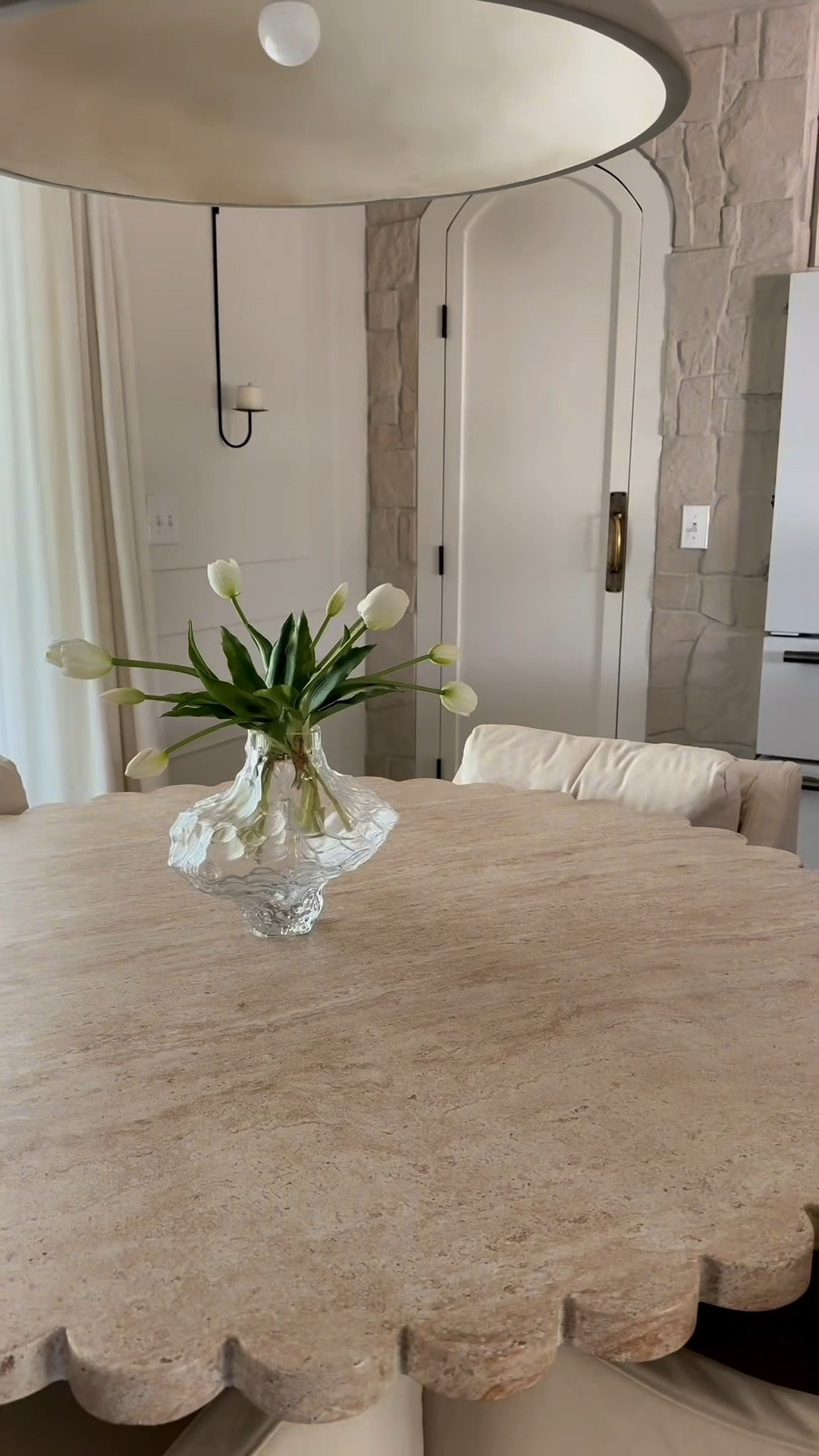 A simple and fresh spring kitchen with white faux florals from Amazon. These stems are so good and so affordable. I want to put them everywhere. I also just got this glass vase on my kitchen table and I am OBSESSED. It’s so beautiful in person and has a unique shape. Shop it all here! My chairs are from Sixpenny. Esmé dining chairs in the color beach walk. Cotton canvas. Feather down fill  