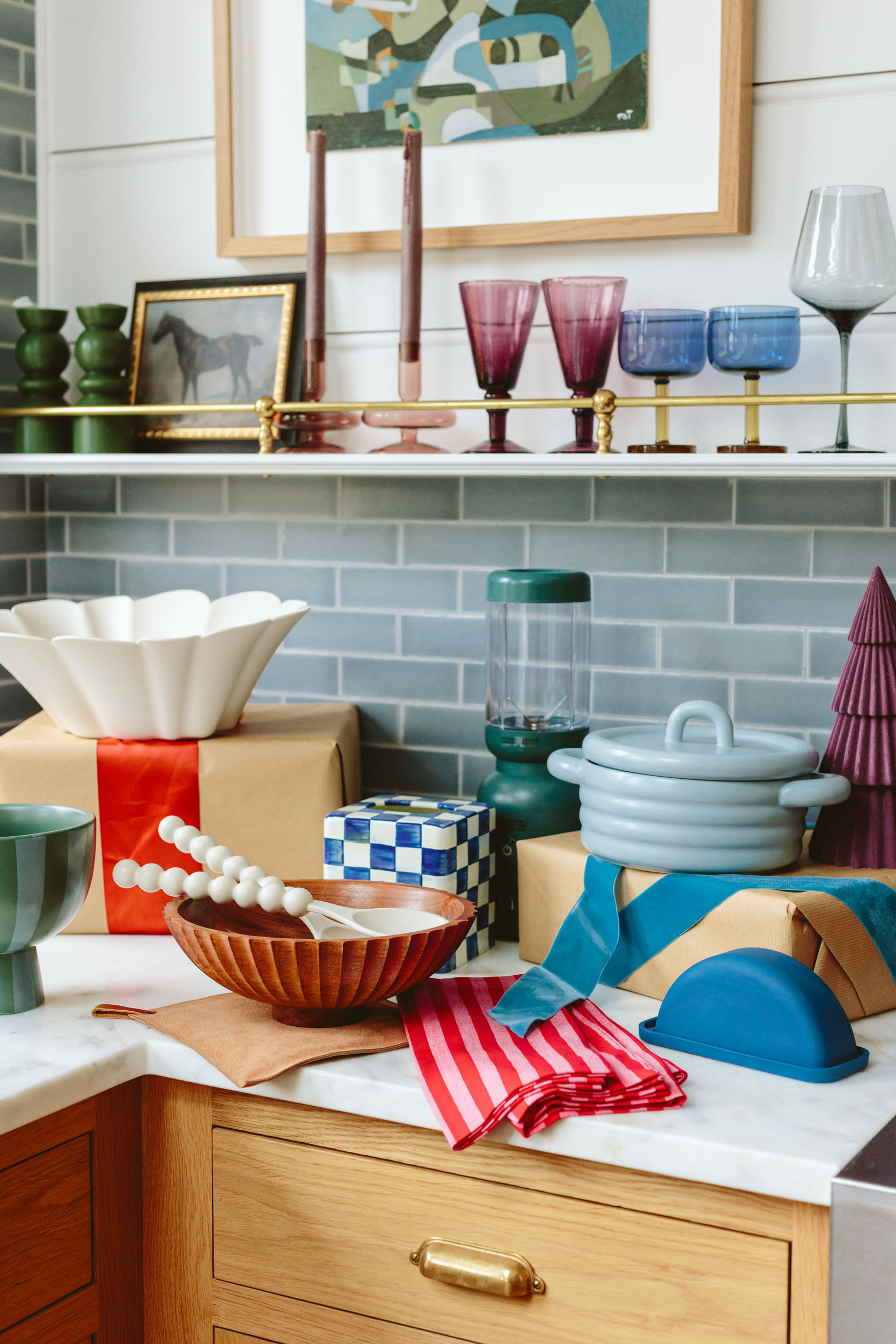 In here I found some pretty awesome stuff for the kitchen that I couldn’t believe how cute and affordable it was – the light blue covered baking dish? SO CUTE (great for sides but also comes bigger in white). The footed blue/green vessel (under $20) and the scallop candle holder (could be year-round on the dining table with nonholiday candles) – both are styling staples. As you can see all of these pieces have something really special about them – either the shape, the texture (the scallop, the round ribbing), or the perfect color.

The red stripe napkins are $3 each and while of course, they are excellent Christmas napkins, red is having such a moment that I’d use it in spring and summer, too. They feel really high quality. The glassware that I collected on the shelves are just better than basic – the two-toned glasses are thick and special (and splurgier) while the purple goblets are affordable and so rich. And don’t forget the $8 glass candle holders – so good, so pretty, so affordable. I have them on my coffee table.

The green blender is countertop worthy (I just bought it for myself and love it), and while that tissue box cover is on the splurgy side it also comes in black and white and it’s metal. Let’s just say it brings me more joy than I originally predicted (I also love the tray version of it and have it on my coffee table).

#LTKFindsUnder100 #LTKGiftGuide #LTKHome