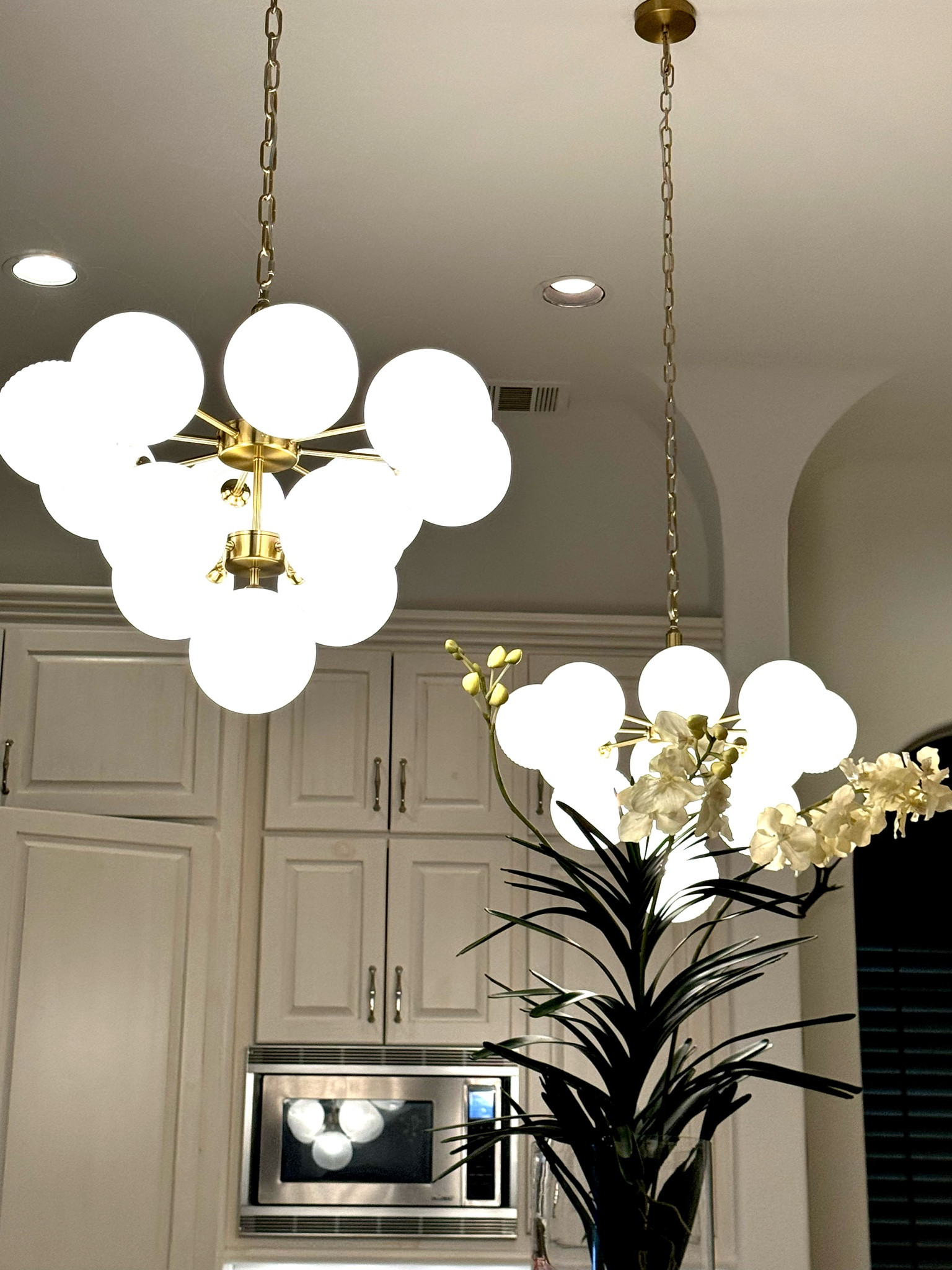 This photo is an actual photo from over my kitchen island 
Elevate your interior decor with the Contemporary Ribbed Glass Bubble Chandelier. This chandelier combines old-world glamour with a modern twist to create a stunning centerpiece for any room. Finished in antiqued brass, the tiered glass globe chandelier exudes refinement and luxury. The white ribbed glass shades diffuse the glow of the G9 bulb (not included) to illuminate every corner of your space. Perfect for larger rooms, this chandelier is a must-have addition to any stylish home.. 
18% off through 7/10/24
Kitchen island pendants
Lighting chandeliers 


#LTKSaleAlert #LTKHome