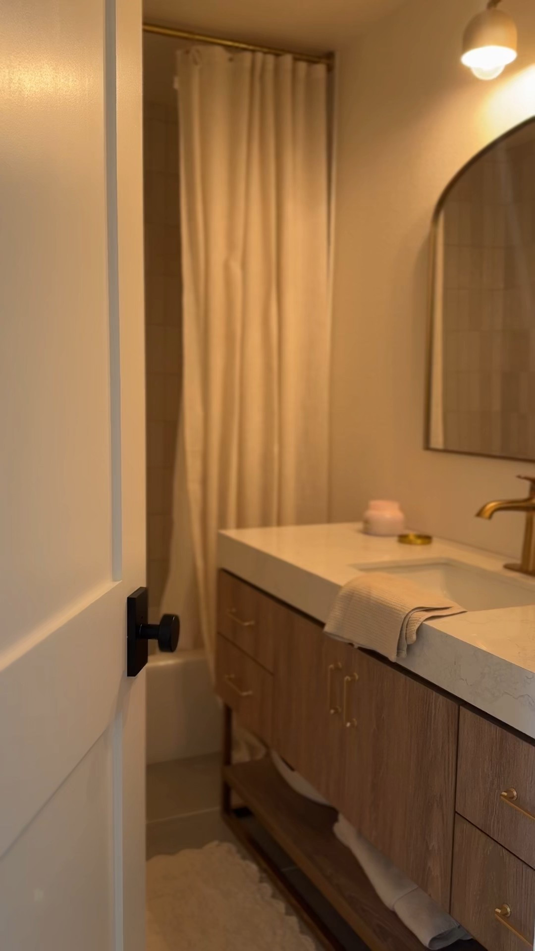 Bathroom remodel / decor / items linked!! Shaker doors, black Amazon door knobs, kohler gold faucet, Alistar vanity, Amazon shower curtain, rod, hooks & liner, the Home Depot Kingston tile also linked + The bath mat is home goods. 

#LTKHome