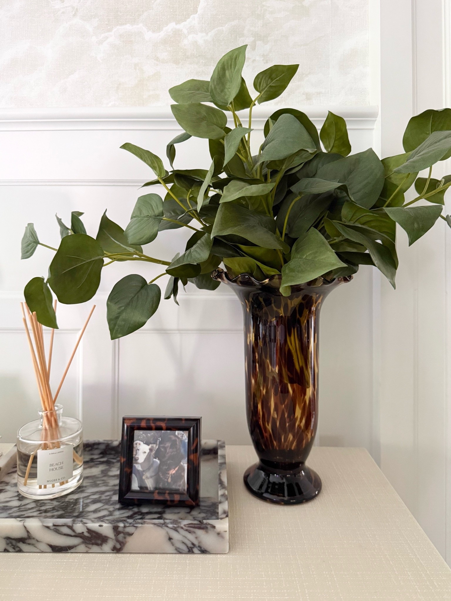 This tortoise shell vase is such a beautiful way to add a little warmth and contrast to a space. I love how the darker glass paired with simple greenery feels collected, classic, and works perfectly with a coastal neutral palette.

tortoise shell vase, faux greenery, coastal home decor, living room styling, console table decor, neutral home decor, classic interior design, collected home style, home decor ideas, organic modern decor, timeless decorating, girlonthehudson

#LTKHome #LTKSeasonal #LTKdayinmylife