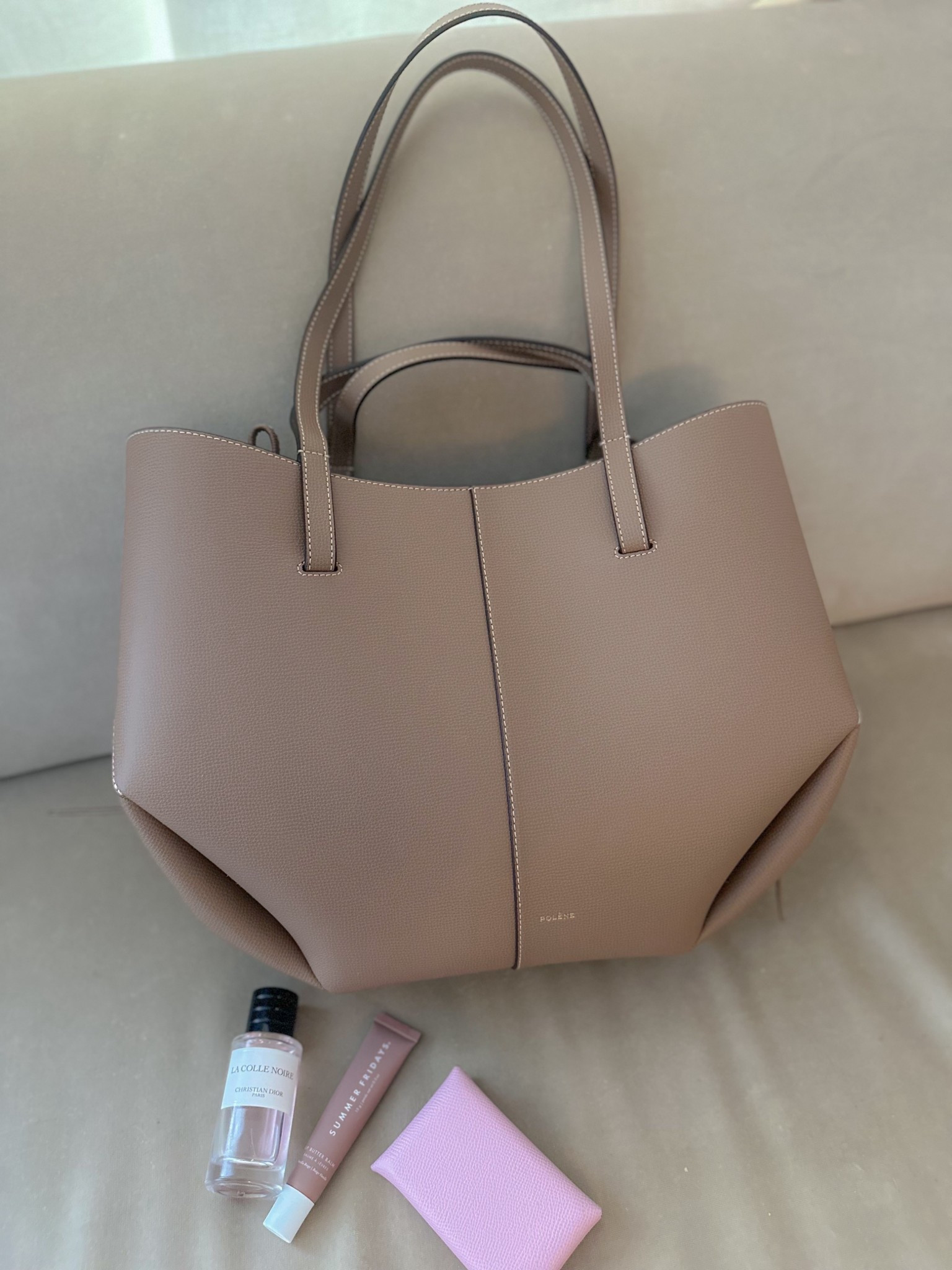 Finally got myself a new work tote: the Polène Cyme in Racine 🤎 

Also featuring my daily essentials: 
- Hermès Calvi cardholder
- Summer Fridays lip butter balm
- Dior La Colle Noire perfume 🩷

#LTKItBag #LTKWorkwear #LTKStyleTip