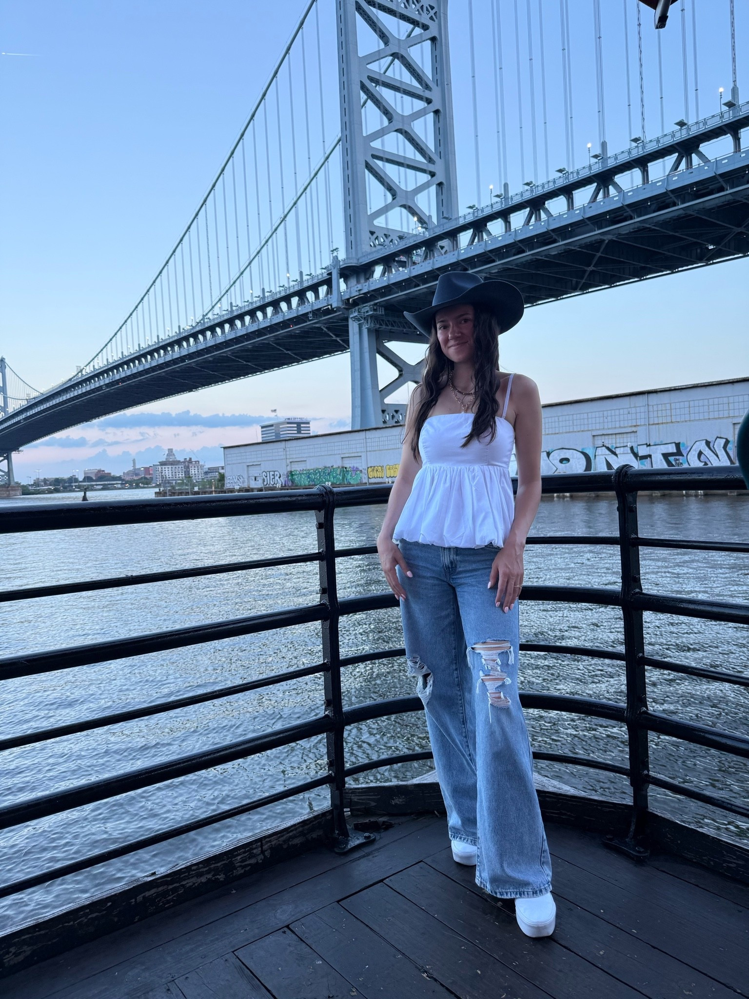Waterfront sunsets with a touch of western flair. 🌉🤠 Paired a crisp white peplum cami with relaxed, distressed wide-leg denim and platform white sneakers for an effortless summer night look. Topping it off with a structured black cowboy hat brings just the right modern edge to a classic city backdrop! @gigipip

#LTKdayinmylife #LTKootd #LTKPetite