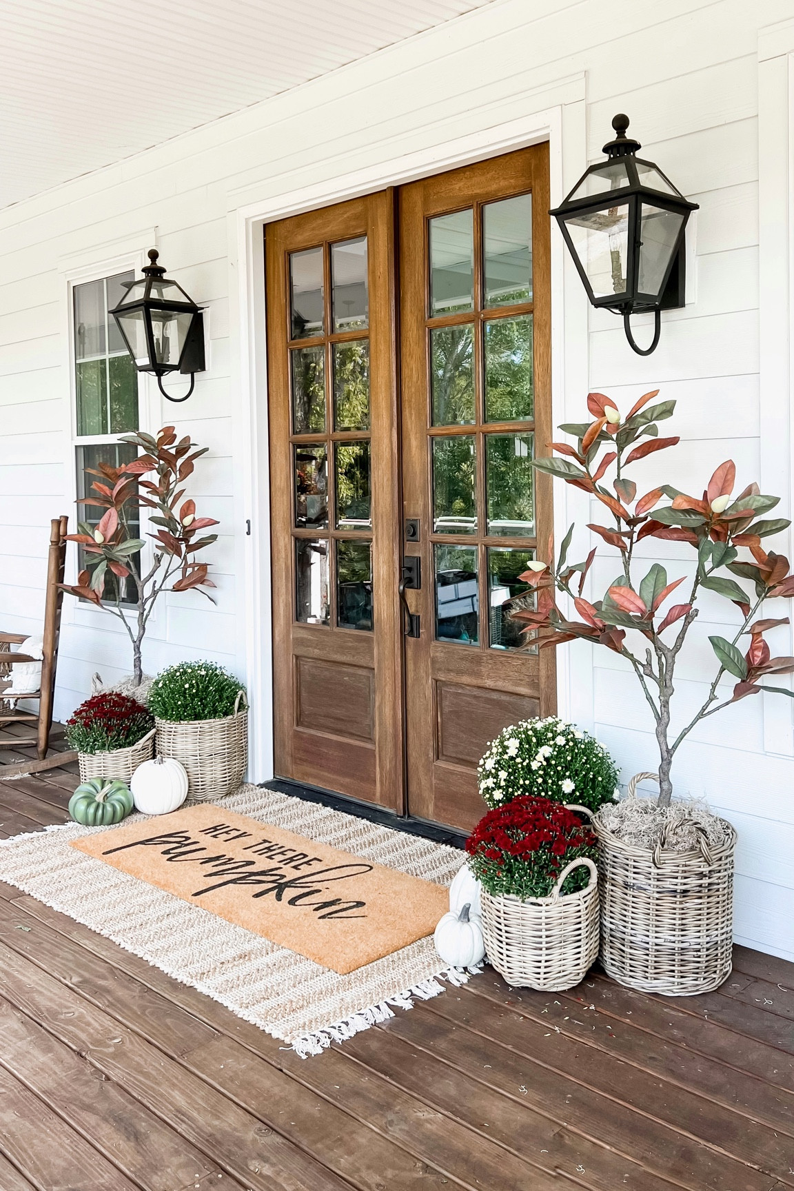 Front porch and door decor fall autumn harvest seasonal entry French double doors oversized layered scatter rug and doormat pumpkin magnolia trees faux florals mums baskets wreaths outdoor lanterns wall sconces rocking chairs

#LTKSeasonal #LTKunder100 #LTKhome