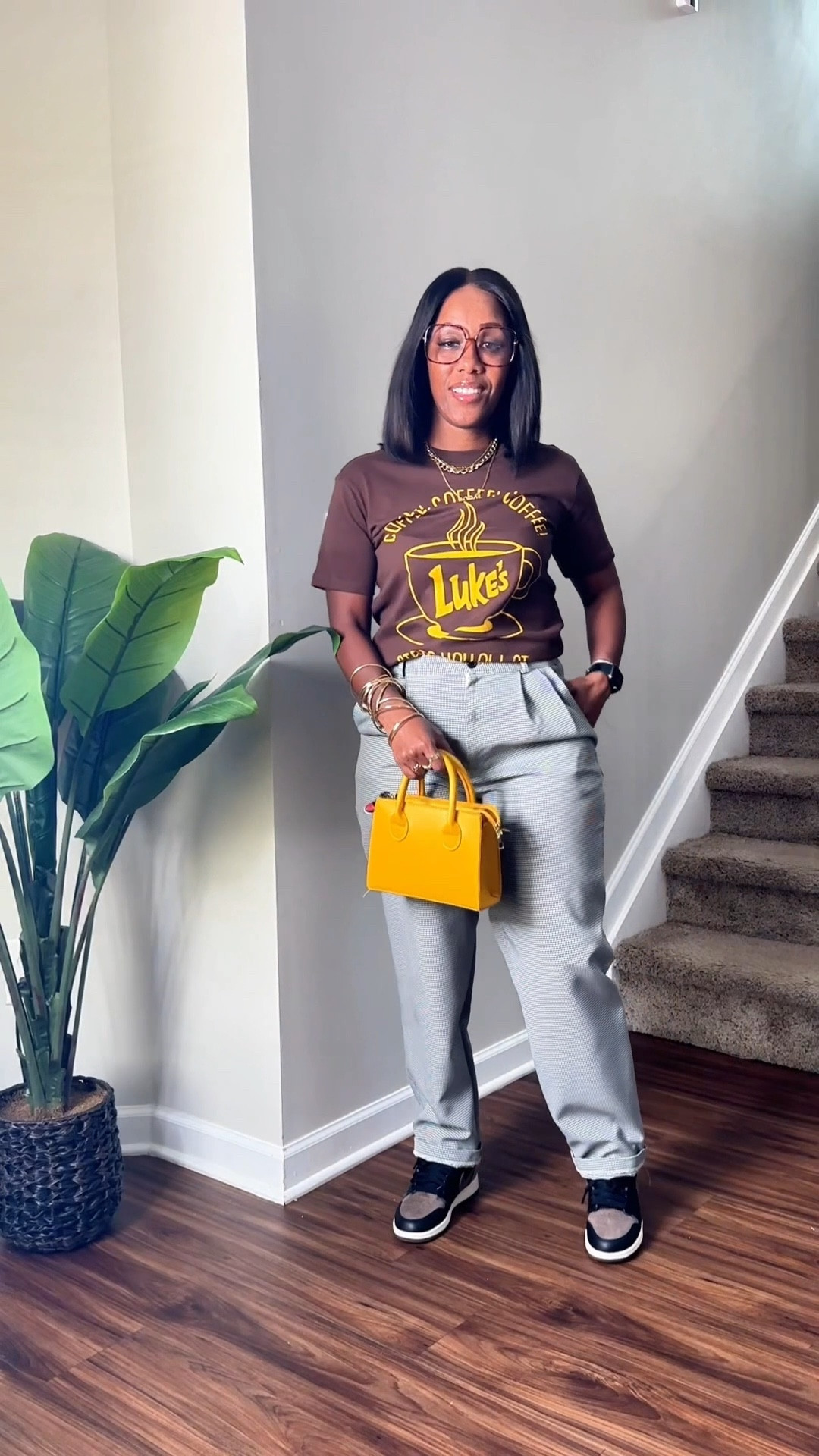 Fall outfit. Brown graphic tee with black and white pleated pants, gold jewelry, yellow purse, leopard print glasses, and Jordan 1 palomino sneakers 

#LTKStyleTip #LTKPetite #LTKFindsUnder50