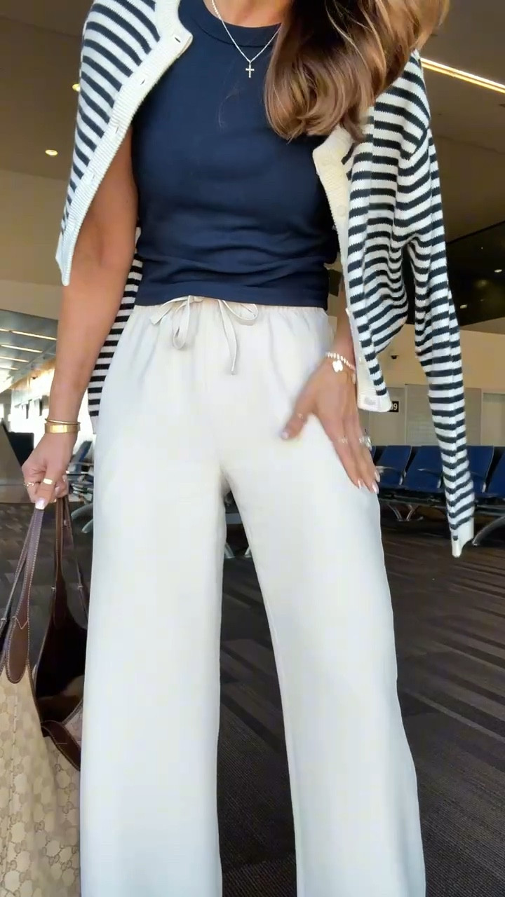 My travel outfit of the day! Aritzia The Lodge Pant - Crepette. Size XS regular, color ‘Metropolis Taupe’. Comes in short and tall, too. Wrinkle resistant with an elastic waist and high-rise. Aritzia t-shirt in XS. Aritzia striped cropped cardigan in 2XS. Jelly ballet flats are whole sizes only. I’m a 6.5 and sized down to a 6 per reviews. Business casual. Elevated casual. Workwear. Coastal outfit. 


#LTKootd #LTKWorkwear #LTKTravel
