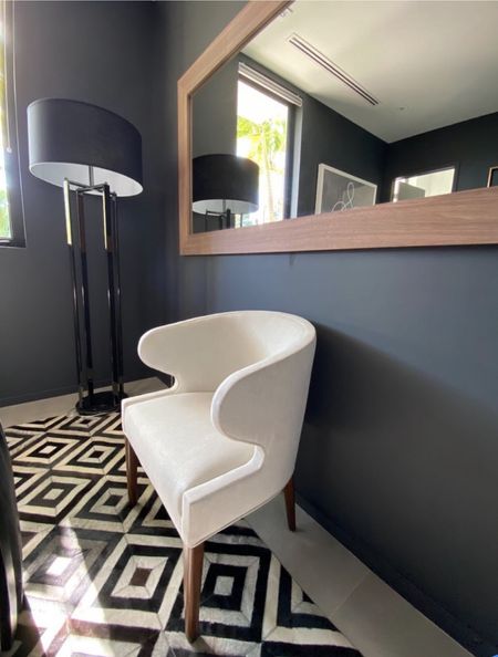 Black and White Neutral Living Room or Bedroom with white accent chair, mirror, black and white rug.

#LTKstyletip #LTKhome