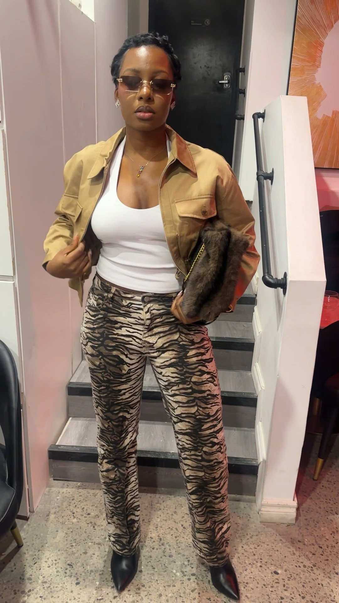 Tiger print med rise trouser, white halter top, black booties, cotton jacket and brown bag 

#LTKSpringSale #LTKootd