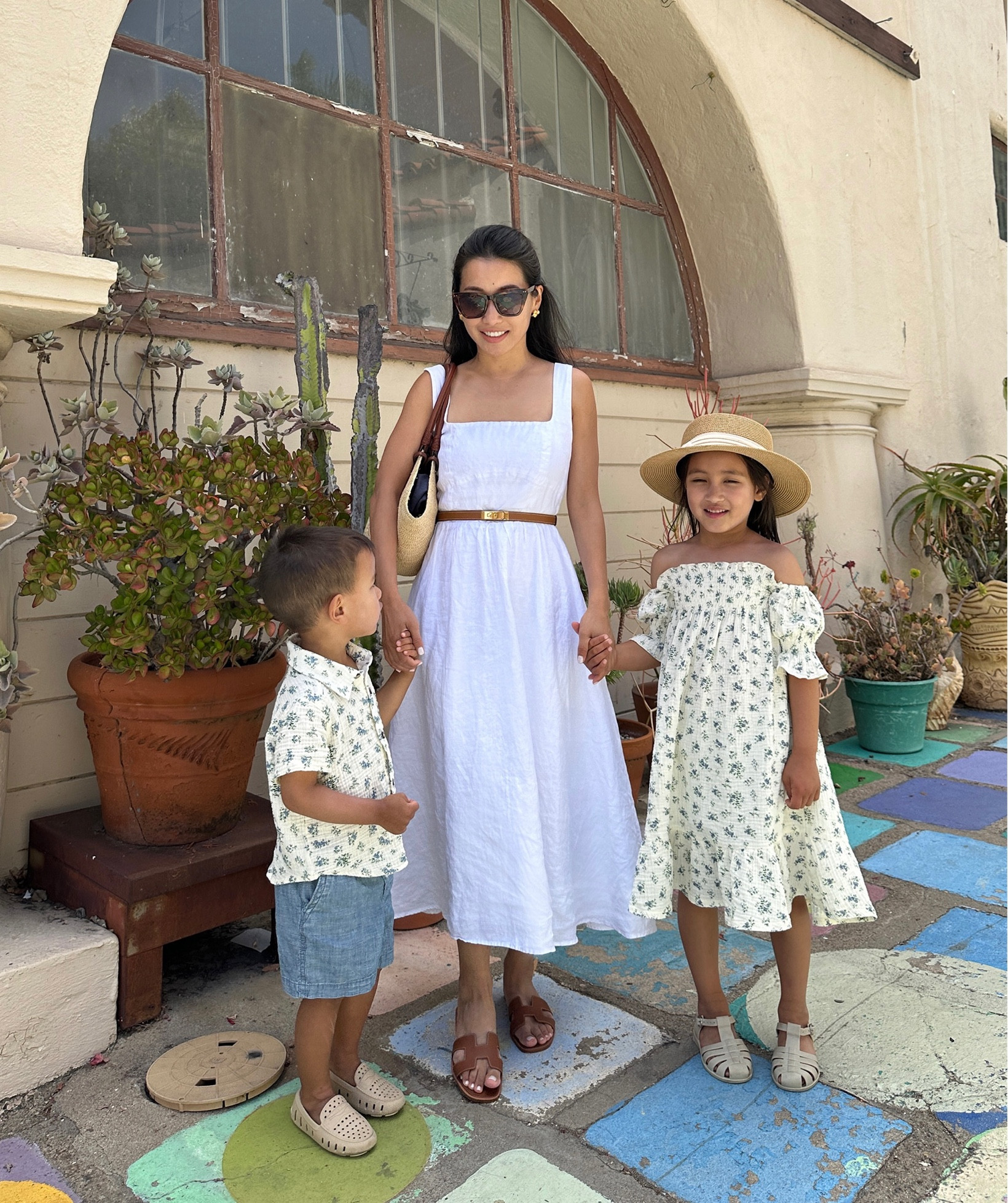 • 100% linen dress Xs altered at the torso to fit slimmer .

In my opinion this is one of quince’s best pieces in terms of style (SO classic and flattering!) but XS is sadly too loose for me at the torso. I usually wear xxs, and can get away with some quince XS pieces but this was roomy.

Stretch back panel, pockets, and adjustable straps. Straps fit me in length. I loved this enough to alter and take the sides of the torso in. 

• Reformation has a similar gorgeous linen dress that is higher quality, with more detailed construction,  runs smaller and comes in petite sizes 

• morning lavender cotton linen girls dresses and boys siblings matching shirt . So cute. Shrinks in the wash so size up! 

• Hermes belt and sandals 

• Rio is in floafer waterproof shoes 
• nori is in liewood jelly sandals and adjustable fit amazon hat 