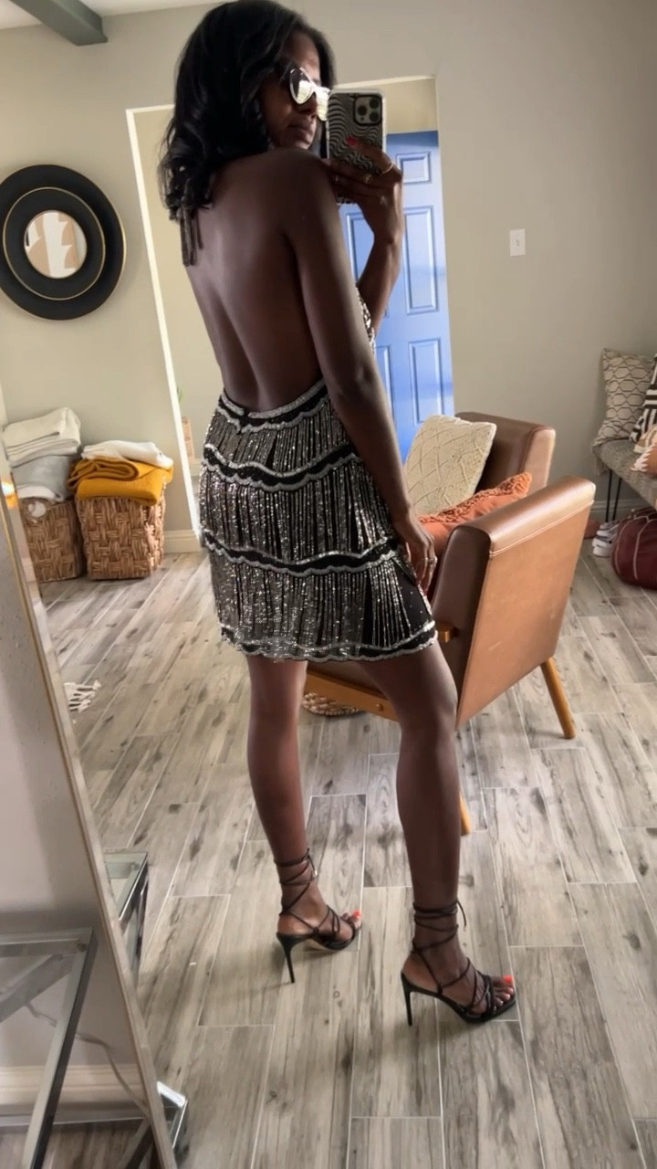 A must have for upcoming holiday events. Black halter dress with beaded fringe, black lace up heels and black cat eye sunglasses  I’m wearing a size small. 

#LTKstyletip #LTKSeasonal #LTKshoecrush