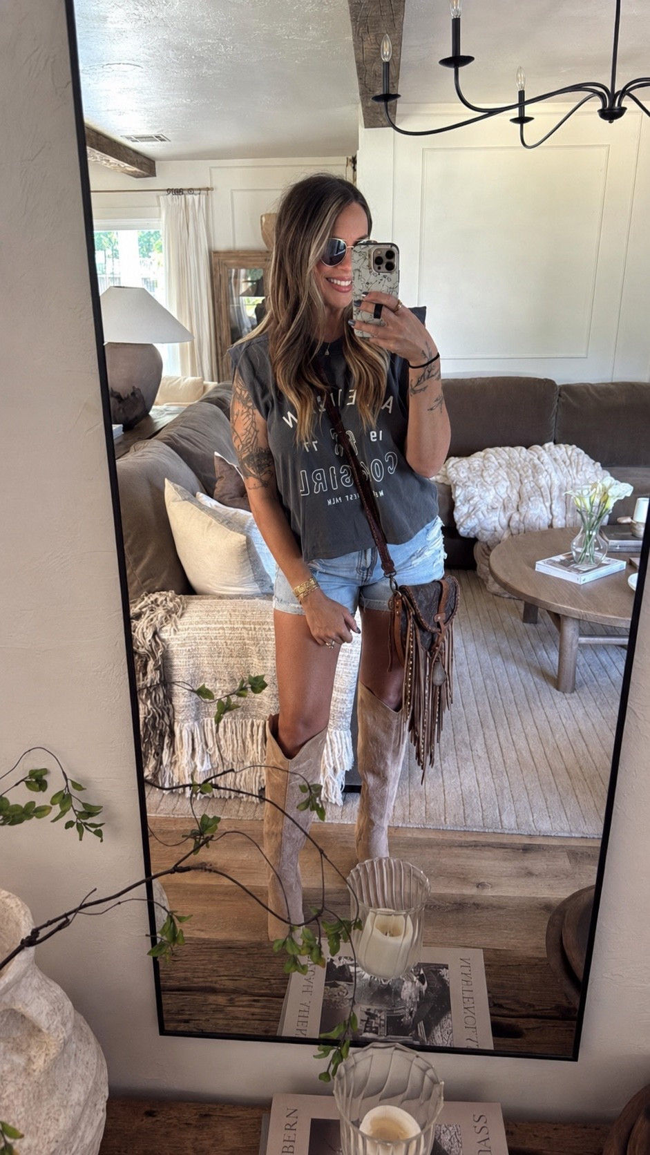 Cute western cut off tee from Vici! Paired with denim shorts and knee high cowgirl boots. These boots are comfy! Western concert festival summer outfit. My bag is vintage boho bags.

#LTKSaleAlert #LTKMidsize #LTKootd