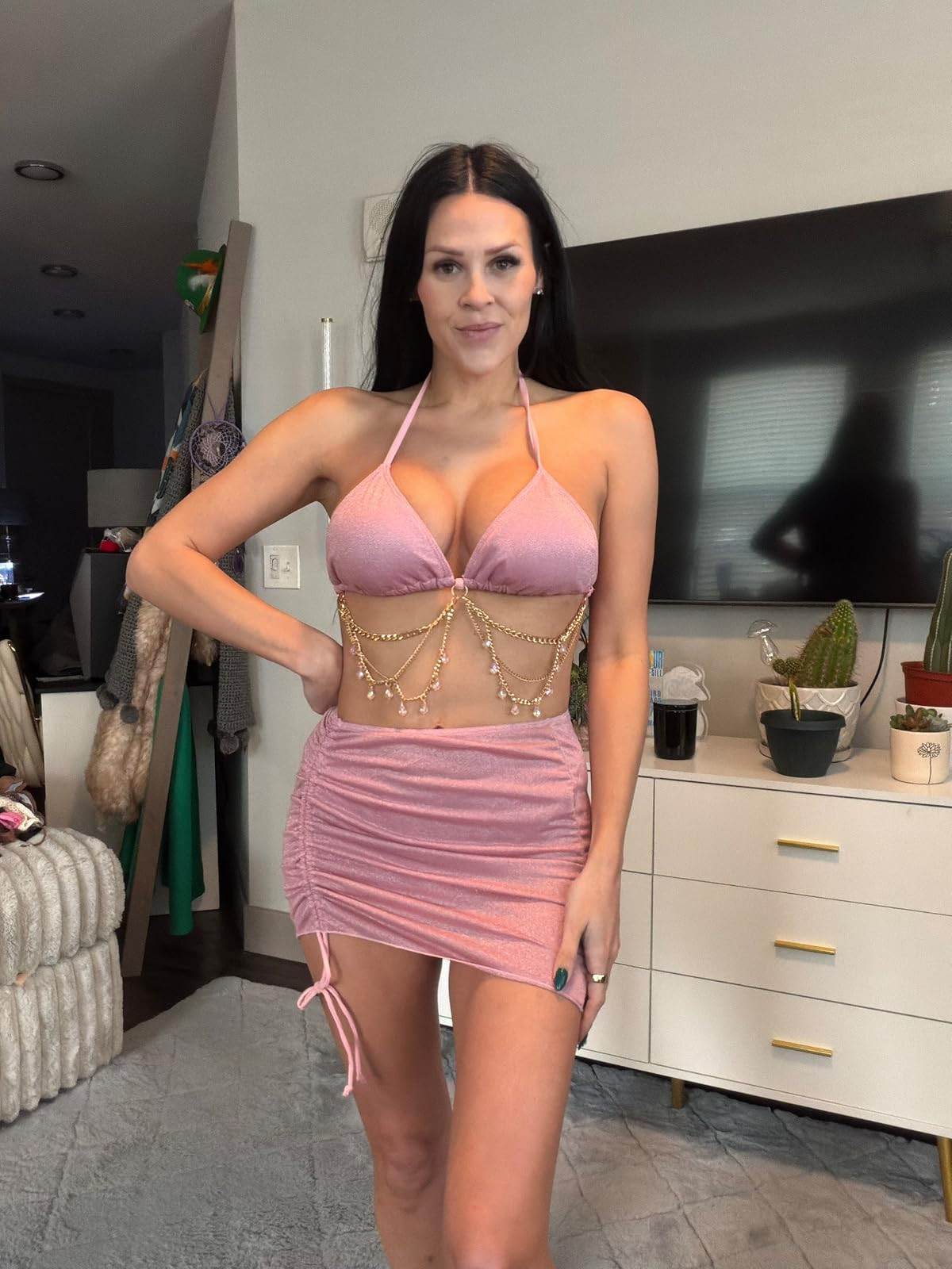 Sparkle and shine. This head-turning festival look features a shimmering pink halter top with tiered gold body chains, paired with a matching ruched mini skirt. #FestivalOutfit #PinkAesthetic #LTKparty 

 #LTKdayinmylife #LTKgrwm #LTKootd