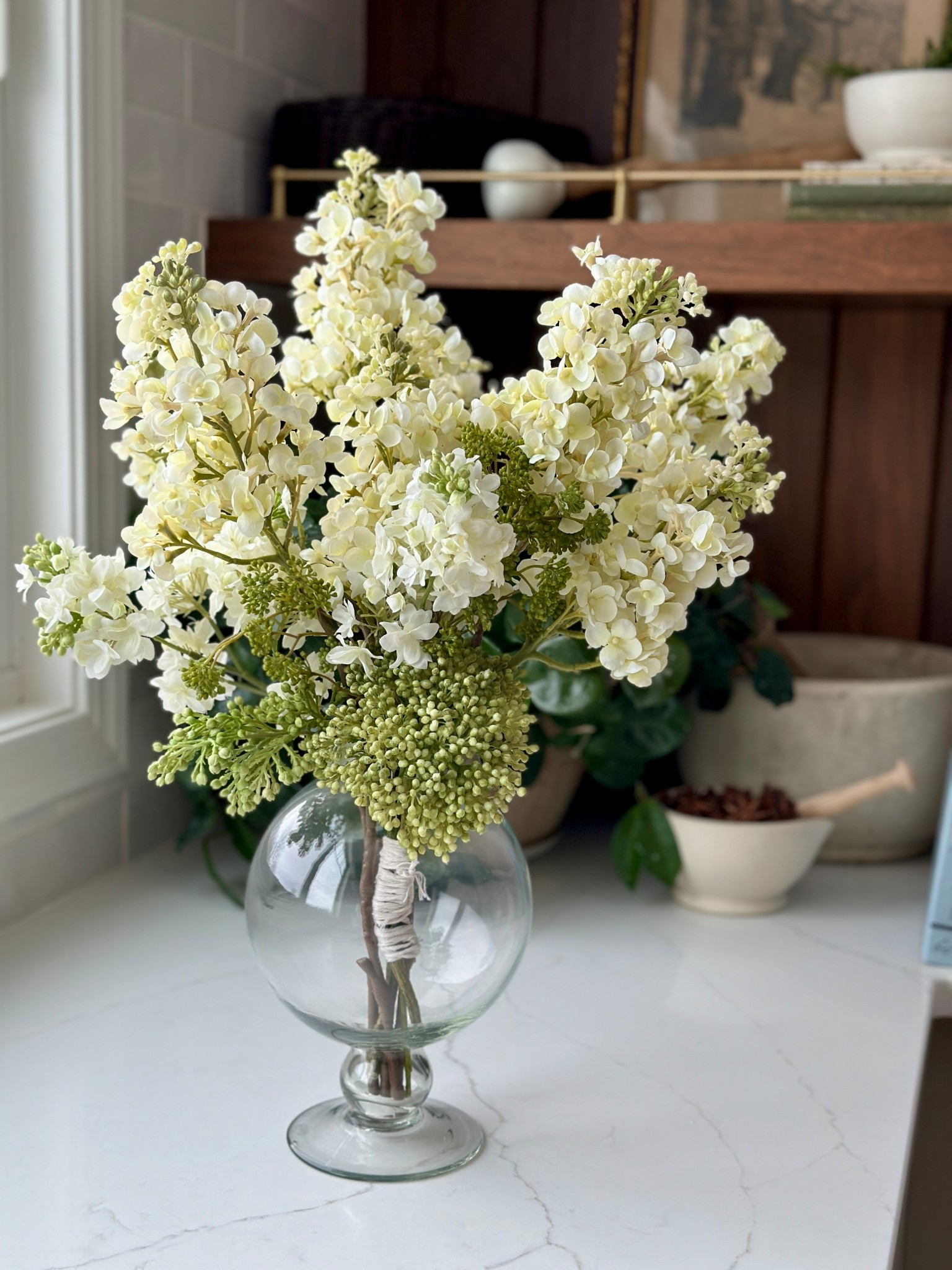 The best affordable faux lilac stems! Perfectly paired with this cute vase  

#LTKHome #LTKSeasonal