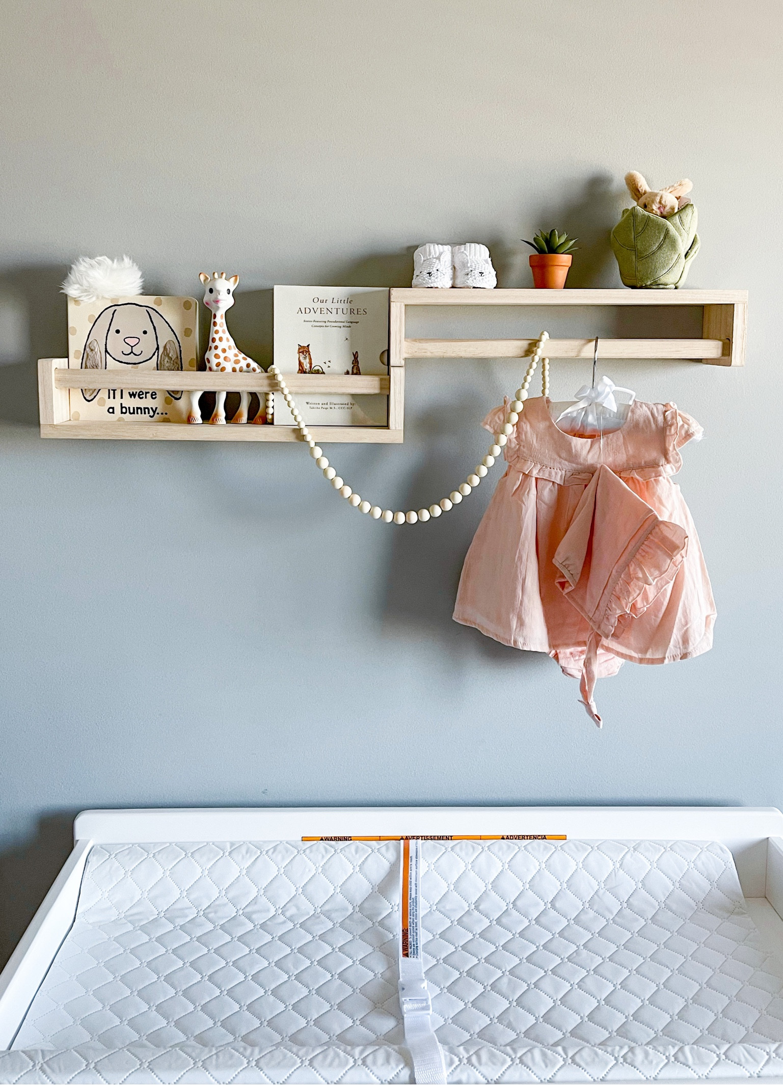 Nursery shelves. We hung one upside down to use a a clothing rod/shelf. Shelves, changing pad & dresser all from Amazon. 