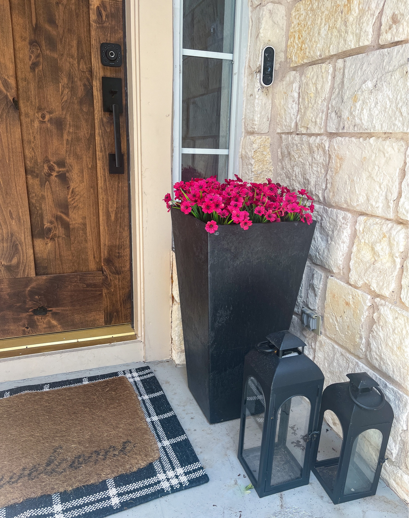 Patio decor: artificial outdoor flowers, tall black planter, affordable lanterns, and a layered front door mat  

#LTKstyletip #LTKSeasonal #LTKhome