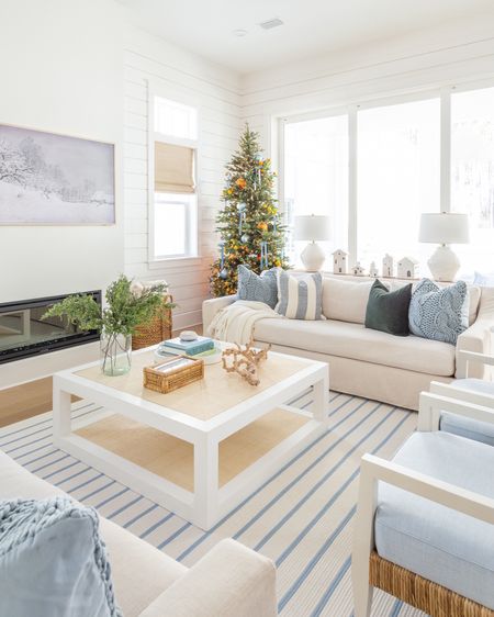 A peek at our citrus Christmas tree in our coastal living room! Includes our 9’ prelit Christmas tree decorated with orange stems, blue velvet bows, a blue and white striped rug, linen sofas, raffia coffee table, cane box, cableknit pillow covers, velvet pillows, a white ceramic Christmas Village and Frame TV. Several items are on sale too! See more of my citrus Christmas decor here: https://lifeonvirginiastreet.com/citrus-christmas-decor/.
.
#ltkhome #ltkholiday #ltksalealert #ltkstyletip #ltkfindsunder50 #ltkfindsunder100 #ltkcyberweek #ltkover40 #ltkseasonal

#LTKsalealert #LTKhome #LTKHoliday