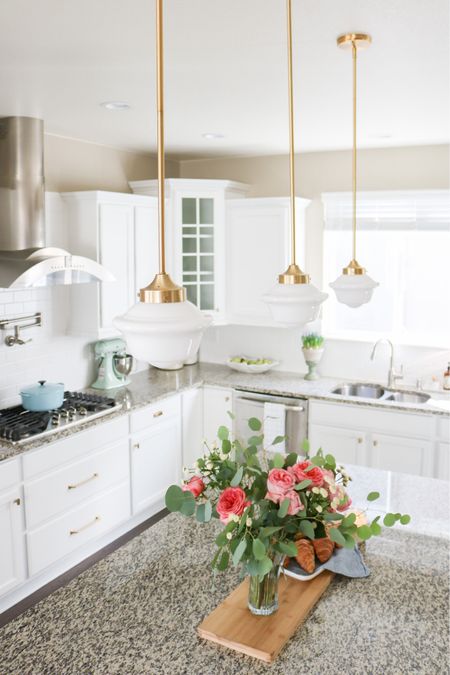 Affordable designer inspired milk glass gold brass pendant lights over kitchen island. Champagne bronze cabinet hardware pulls and knobs  

Granite counters, white kitchen, Kitchenaid mixer, Dutch oven, grandmillenial

#LTKhome