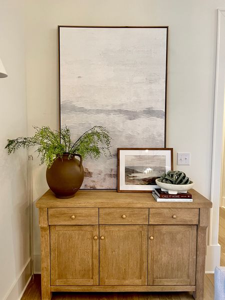 Coastal abstract art above my white oak buffet table! Love the simple styling 

#LTKhome #LTKfamily #LTKSpringSale