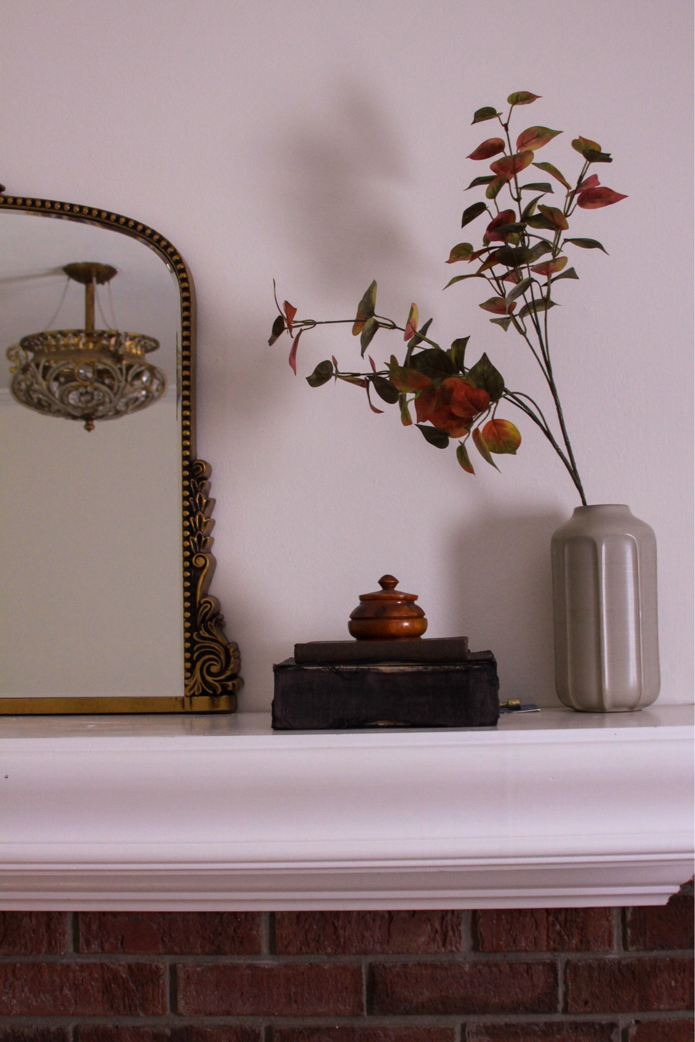 Simple moments on the #livingroom mantle. I love placing a mirror above the fireplace and then arranging little vignettes around it. This single #fall stem adds plenty of height to keep the eye bouncing around from mirror to vintage books and up again. Remember to layer and vary your heights when styling! 

#LTKxWayfair #LTKHome #LTKStyleTip