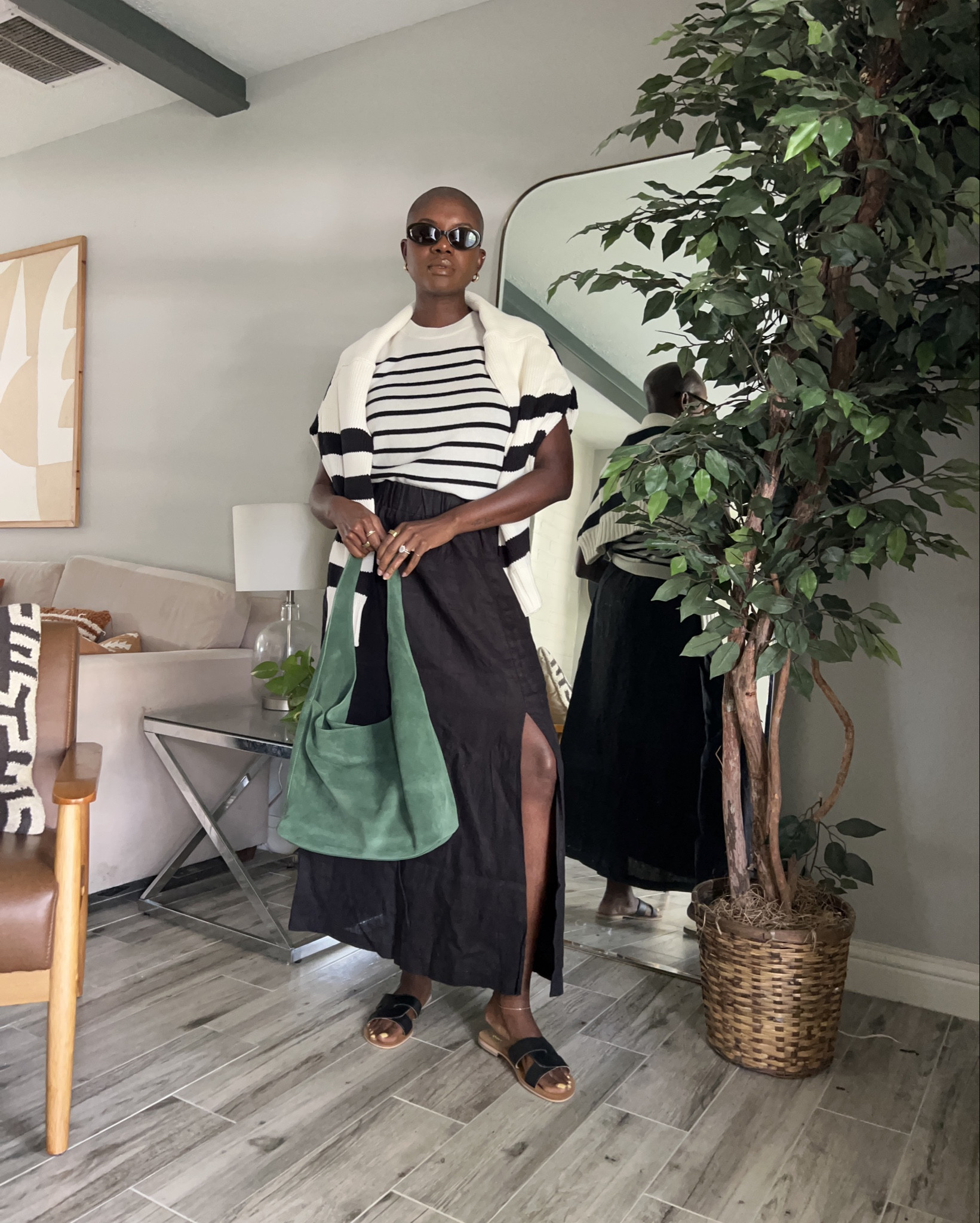 Elevated chic travel outfit from Quince! Black linen maxi skirt with side split, striped cashmere top, green suede purse, black leather sandals, striped knit polo sweater and olive oval sunglasses. 

#LTKTravel #LTKCon #LTKFindsUnder100