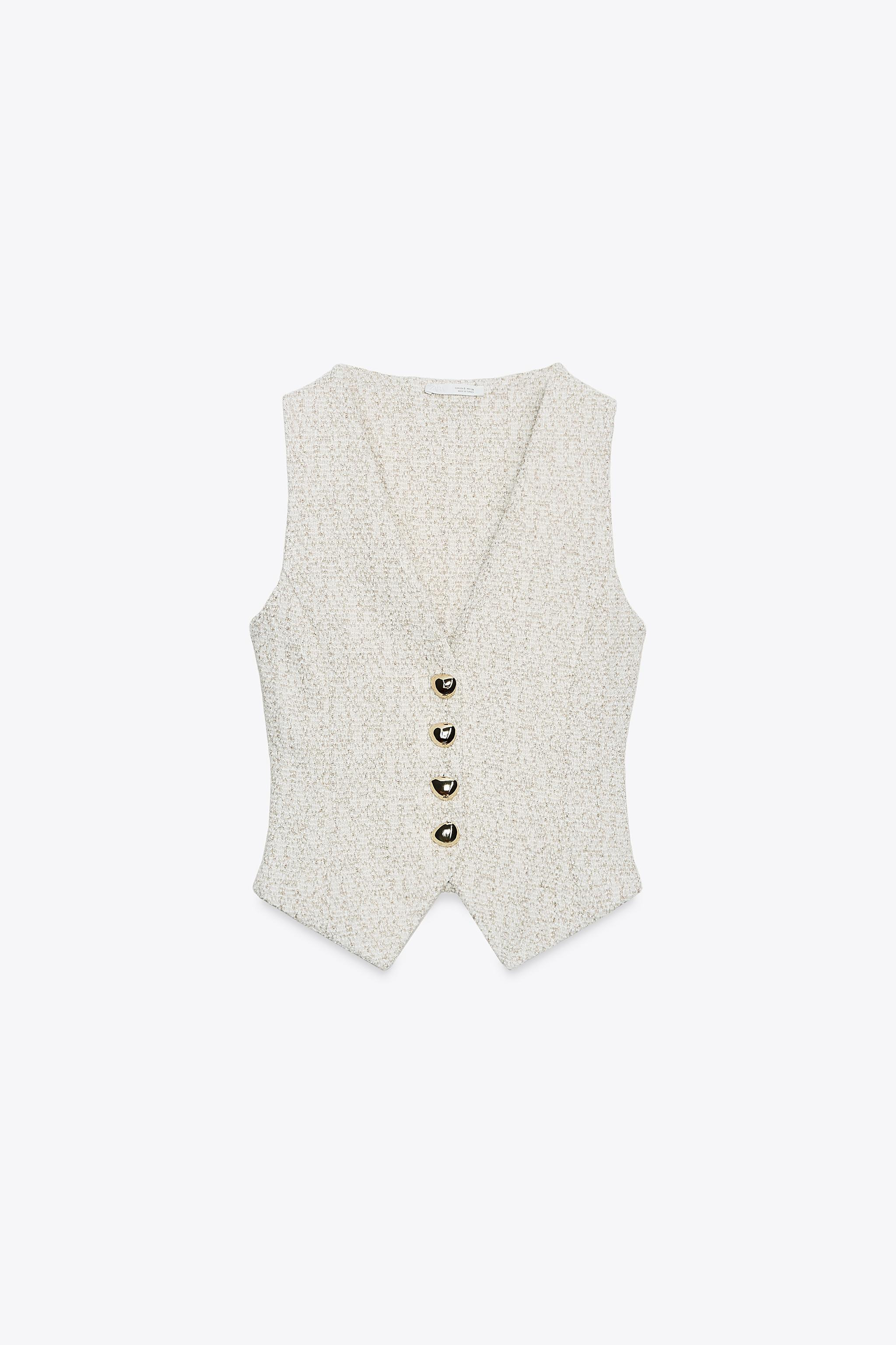 V-neck vest. Textured fabric detail with metallic thread appliques. Asymmetric hem. Front metal b... | Zara US