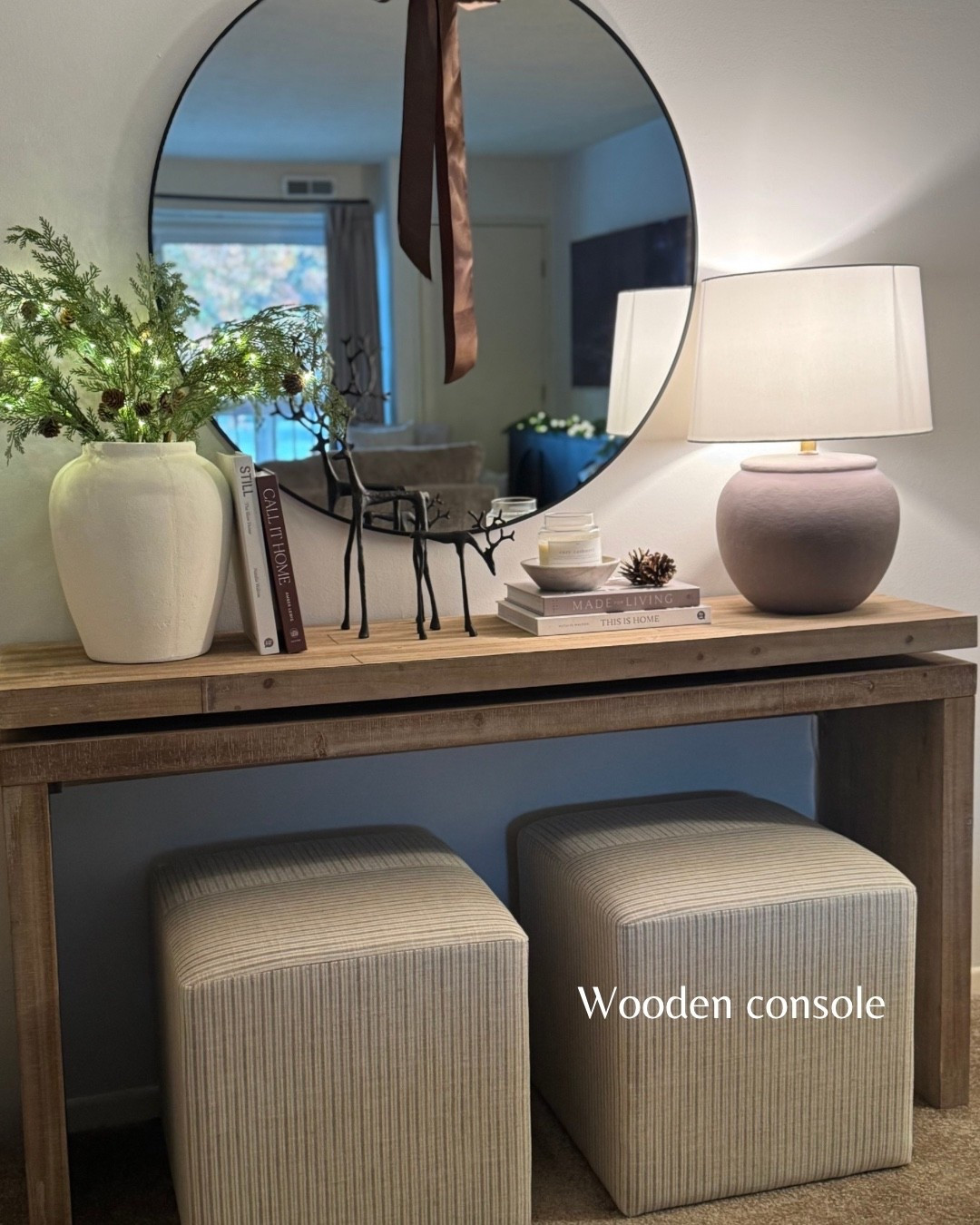 Wood console table, white vase, led lights, Christmas stems, Christmas console table, round mirror, reindeer, coffee table books, candle bowl, stripe ottoman

#LTKCyberWeek #LTKSeasonal #LTKHome