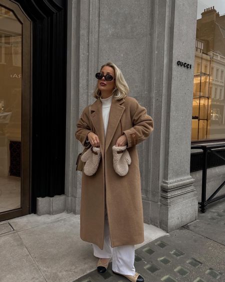 A neutral winter outfit styling this camel coat with a cream knit and cream trousers with the best winter accessory these boucle mittens 

#LTKstyletip #LTKSeasonal