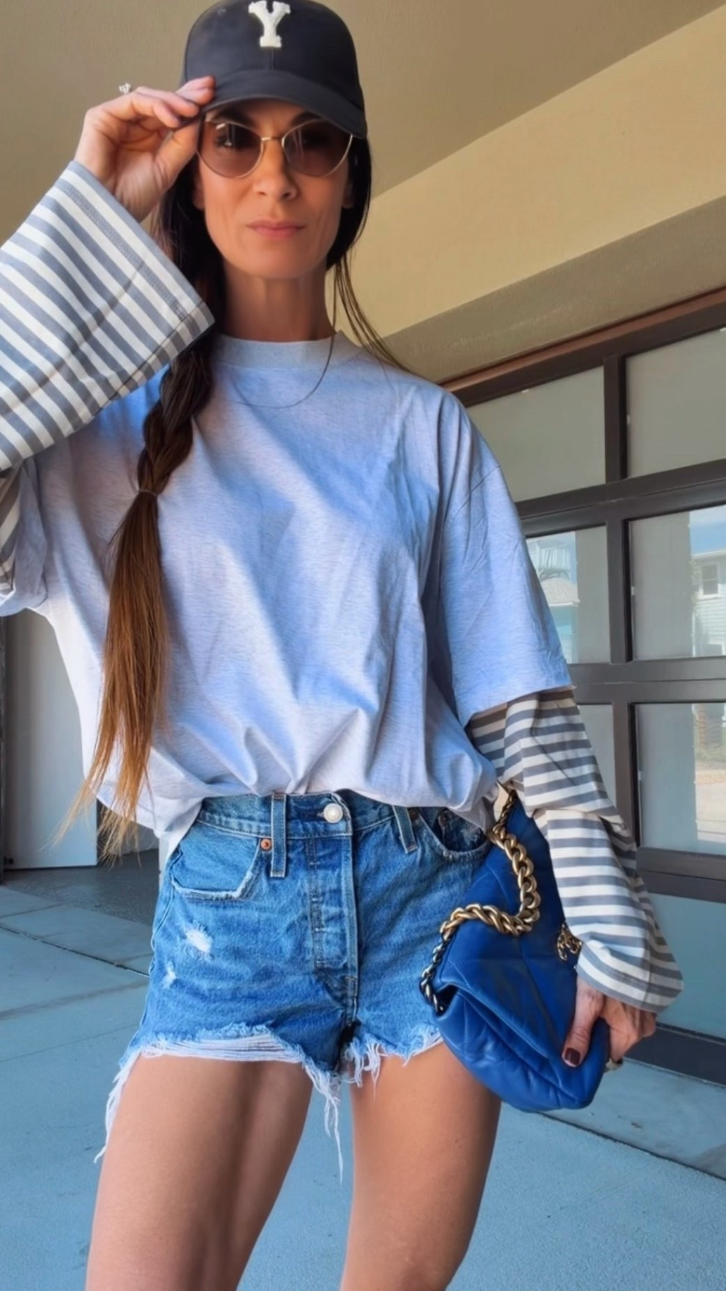 Fall dressing, Florida edition. 💙 Loving the striped sleeve detail on this oversized tee with distressed denim shorts, white sneakers, and a baseball cap. The blue bag adds just enough extra—because apparently even my casual outfits need accessories. 😉 Shop the look here!

#LTKdayinmylife #LTKgrwm #LTKootd