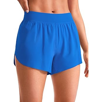 CRZ YOGA Mid Waisted Dolphin Athletic Shorts for Women Lightweight High Split Gym Workout Shorts ... | Amazon (US)